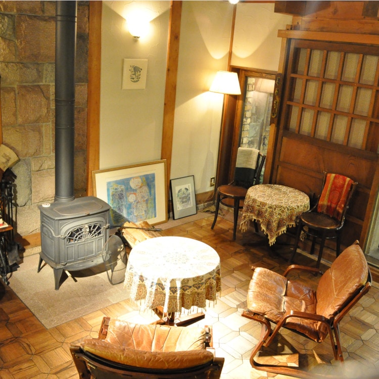 A lounge with a flickering fireplace