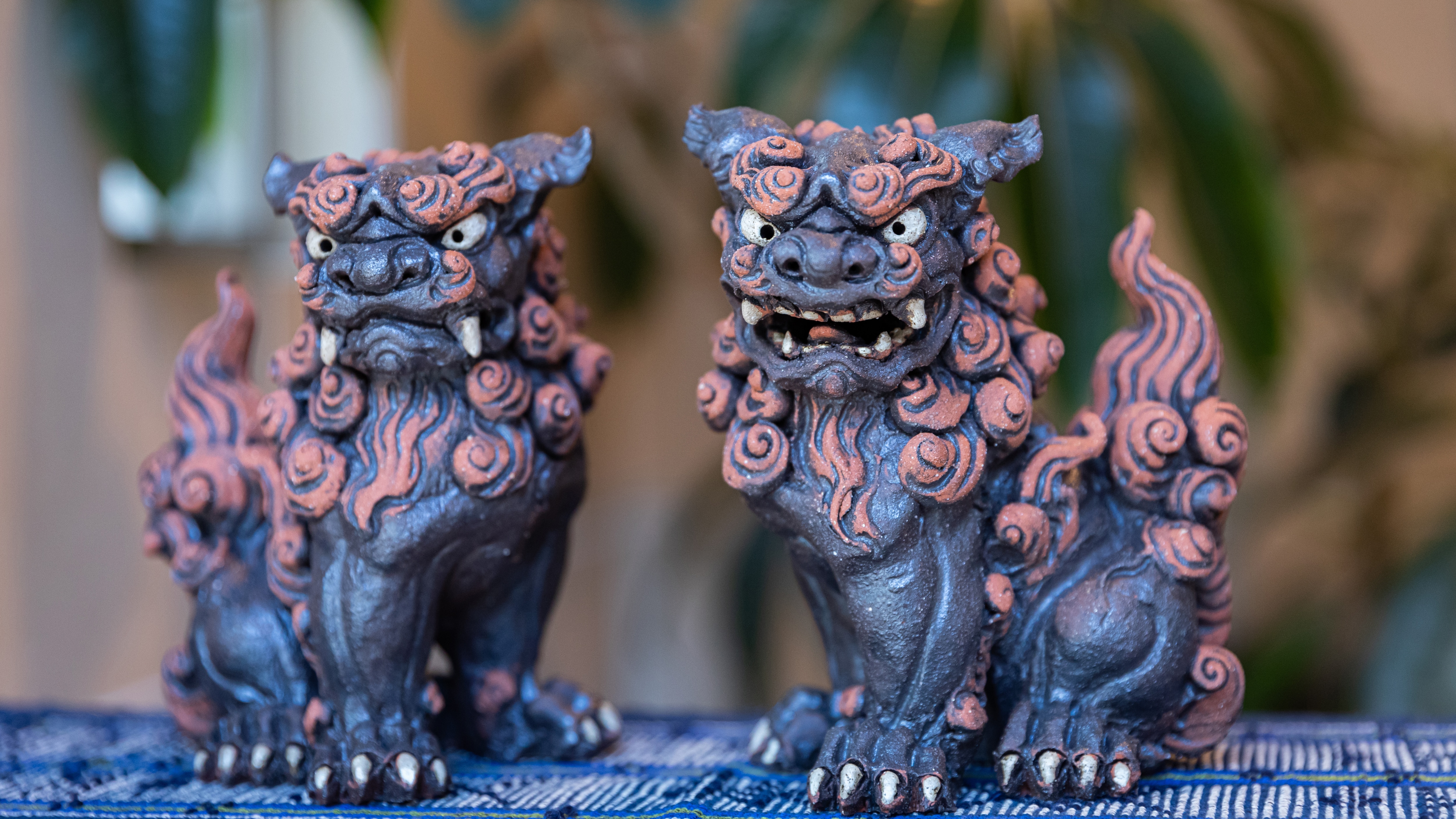 The front Shisa is made by Dr. Hitoshi Naha. The dense and detailed Shisa has a strong presence