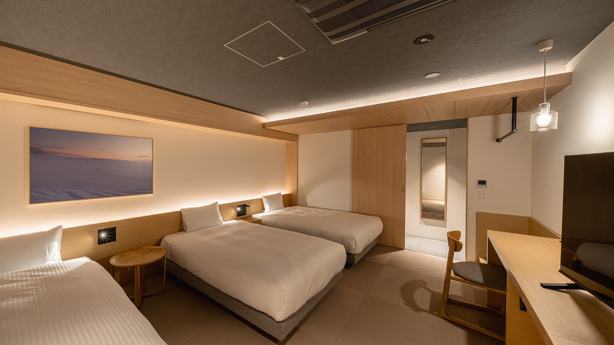 Premier Twin | Image of room for 3 people. Comes with a sofa that can also be used as a bed.