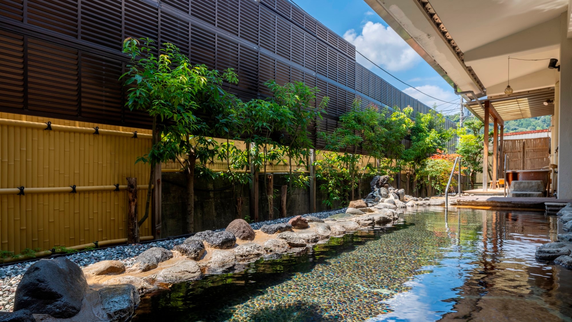 "Genji no Yu" open-air bath surrounded by lush greenery