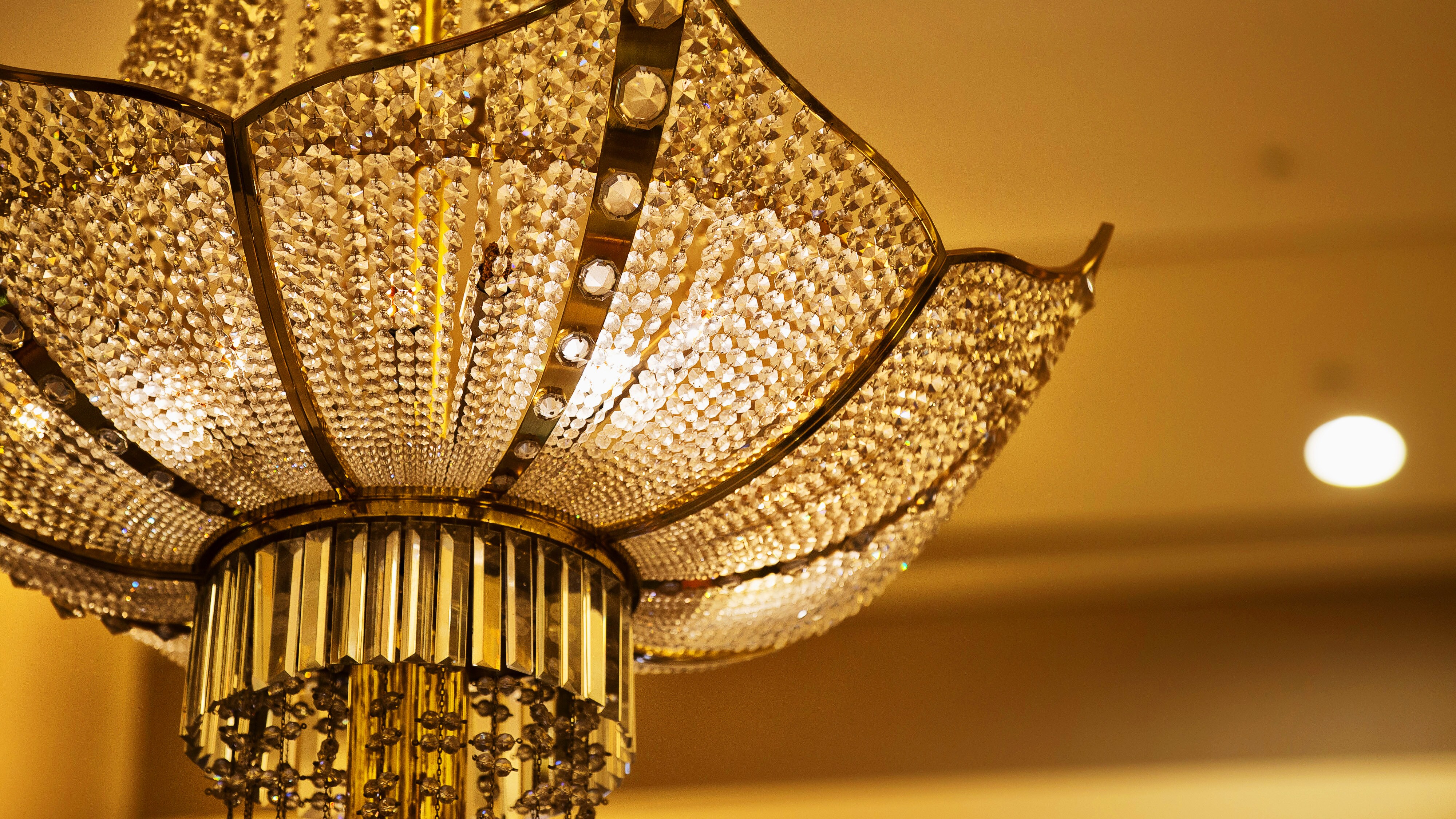 The hotel's signature Lobmeyr chandelier decorates the front desk.