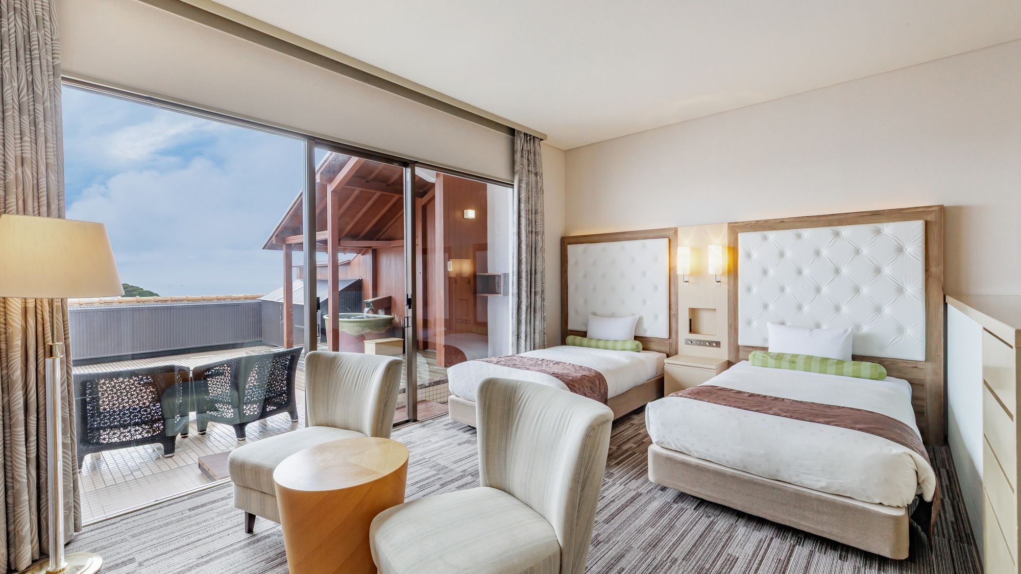 Premium Japanese-Western style room with ocean view and natural open-air hot spring bath.