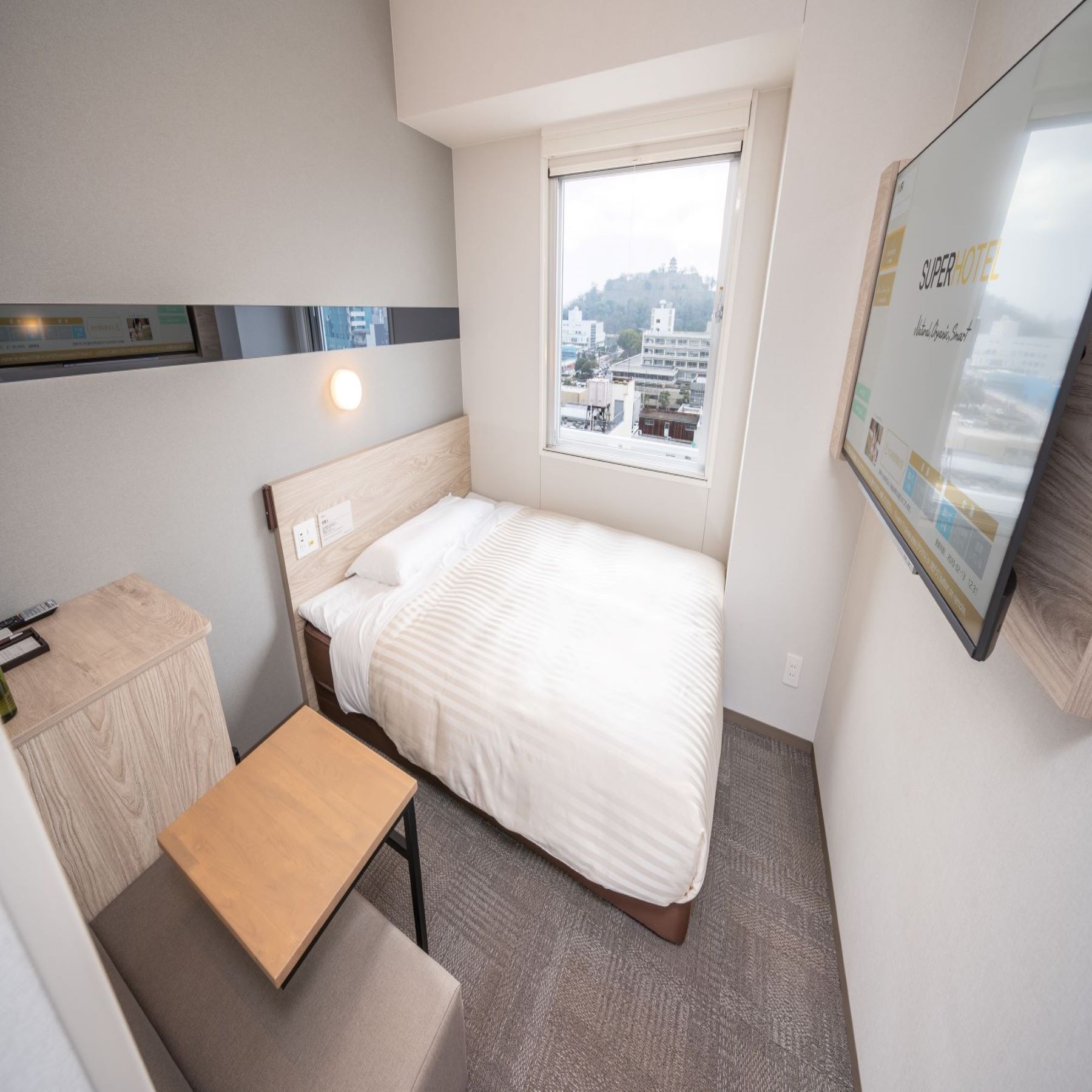 An extra room equipped with a large desk and sofa.