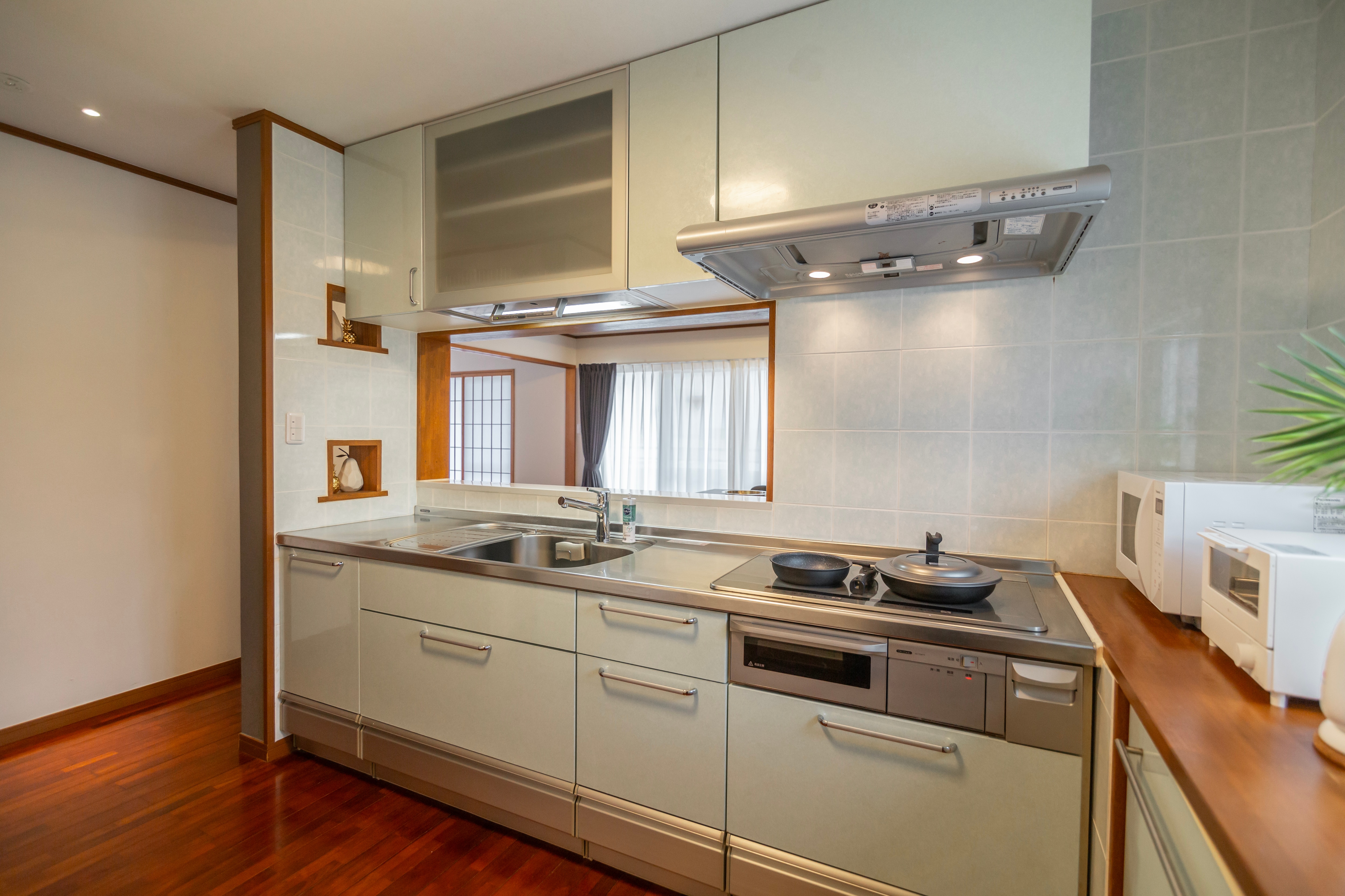 5F Kitchen: IH stove, microwave, toaster, refrigerator, cooking utensils, tableware