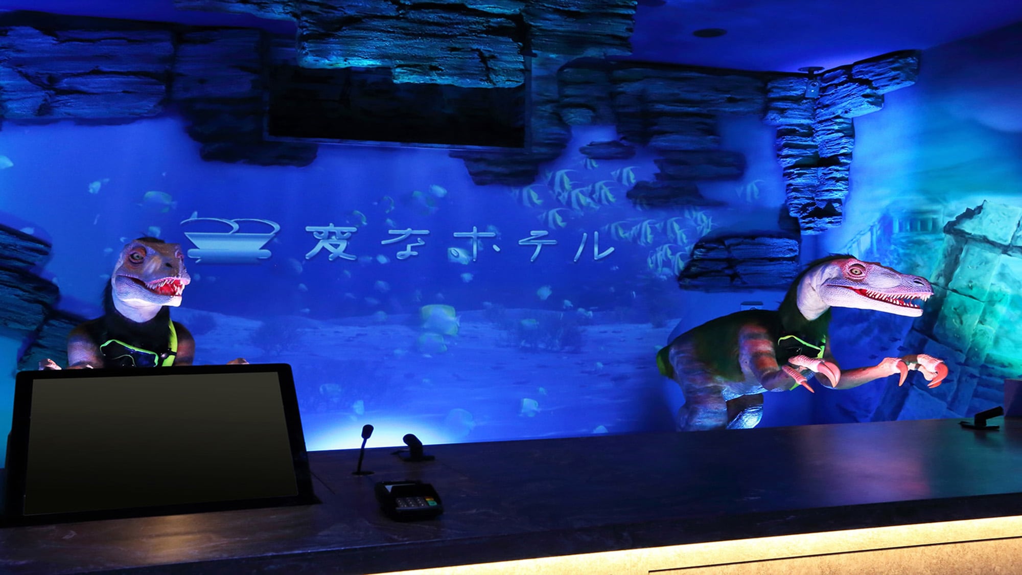 [A dinosaur robot welcomes you at the ocean-like front desk]