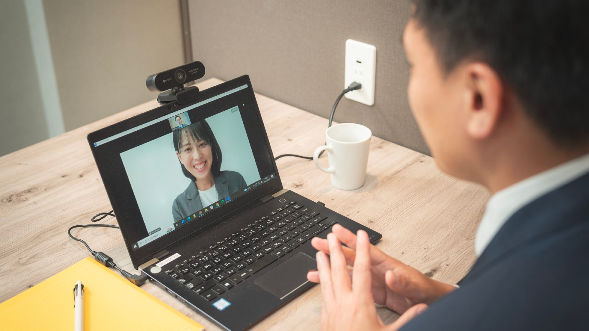A wide desk that is easy to use for web conferences