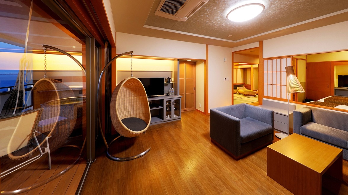 Corner suite, living part of the suite. The terrace is on the left. There is an open-air hot spring bath on the terrace.