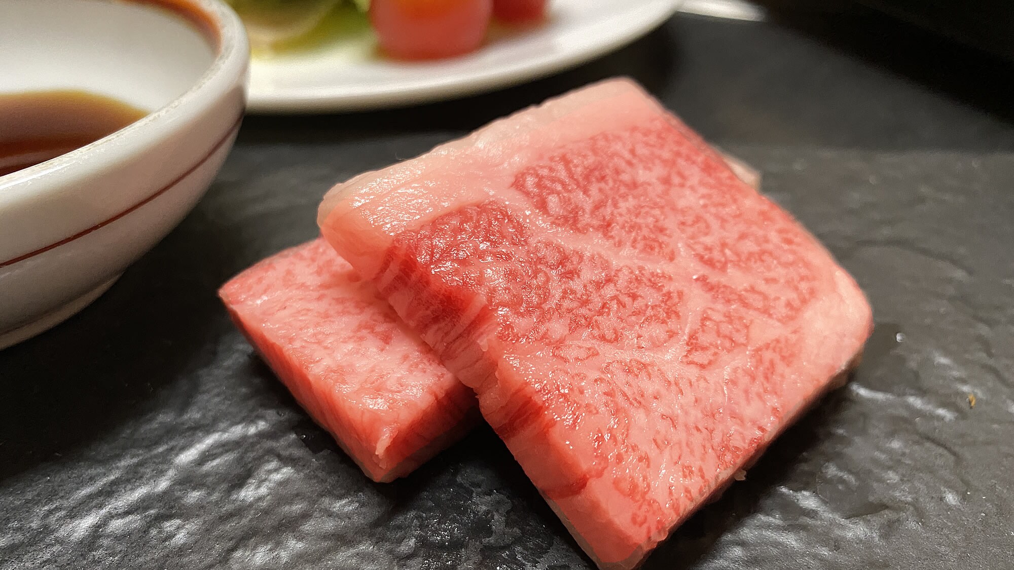 Special Wagyu beef Tomosankaku grilled on a ceramic plate