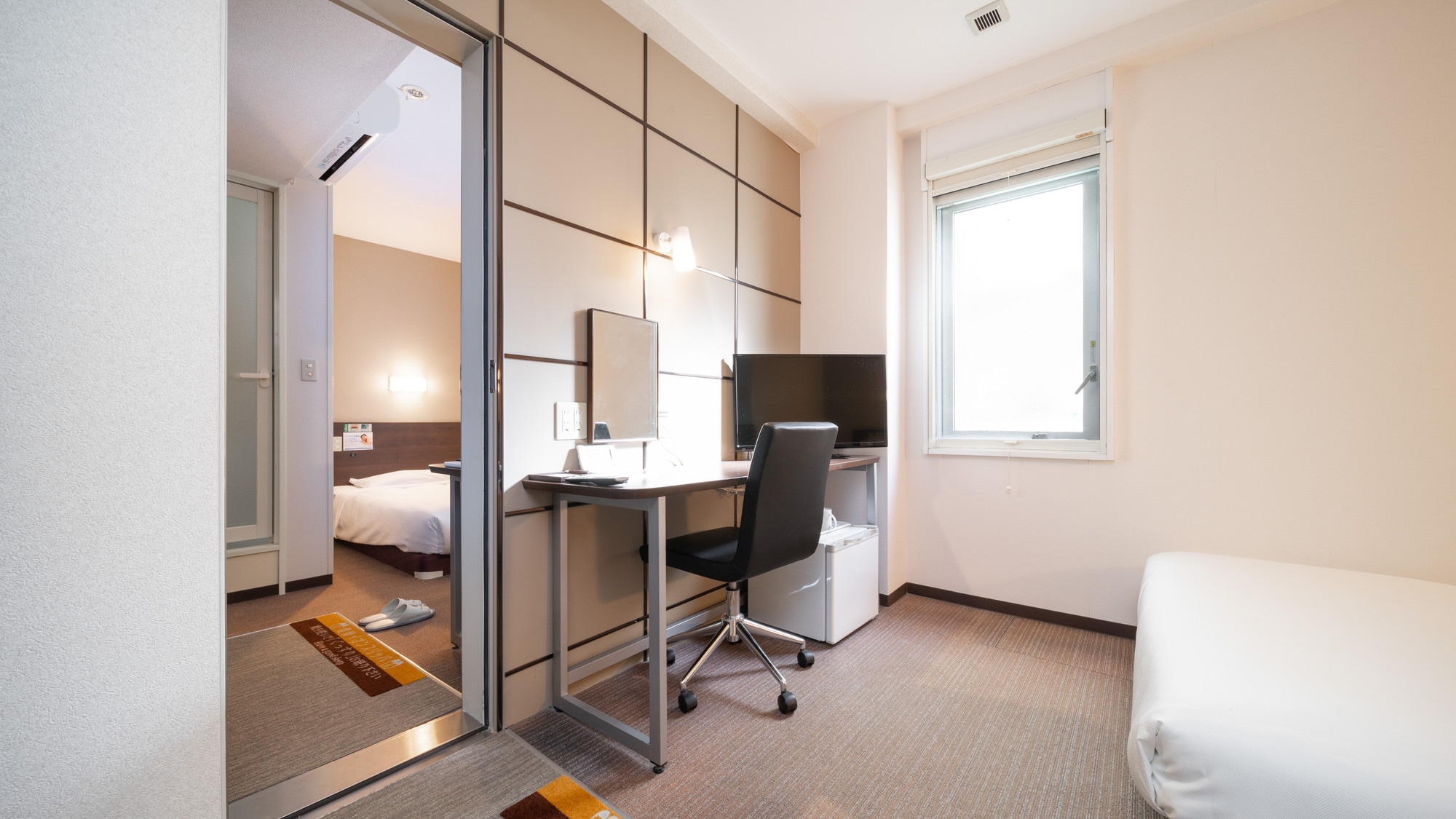 This room has two rooms with a door between them.