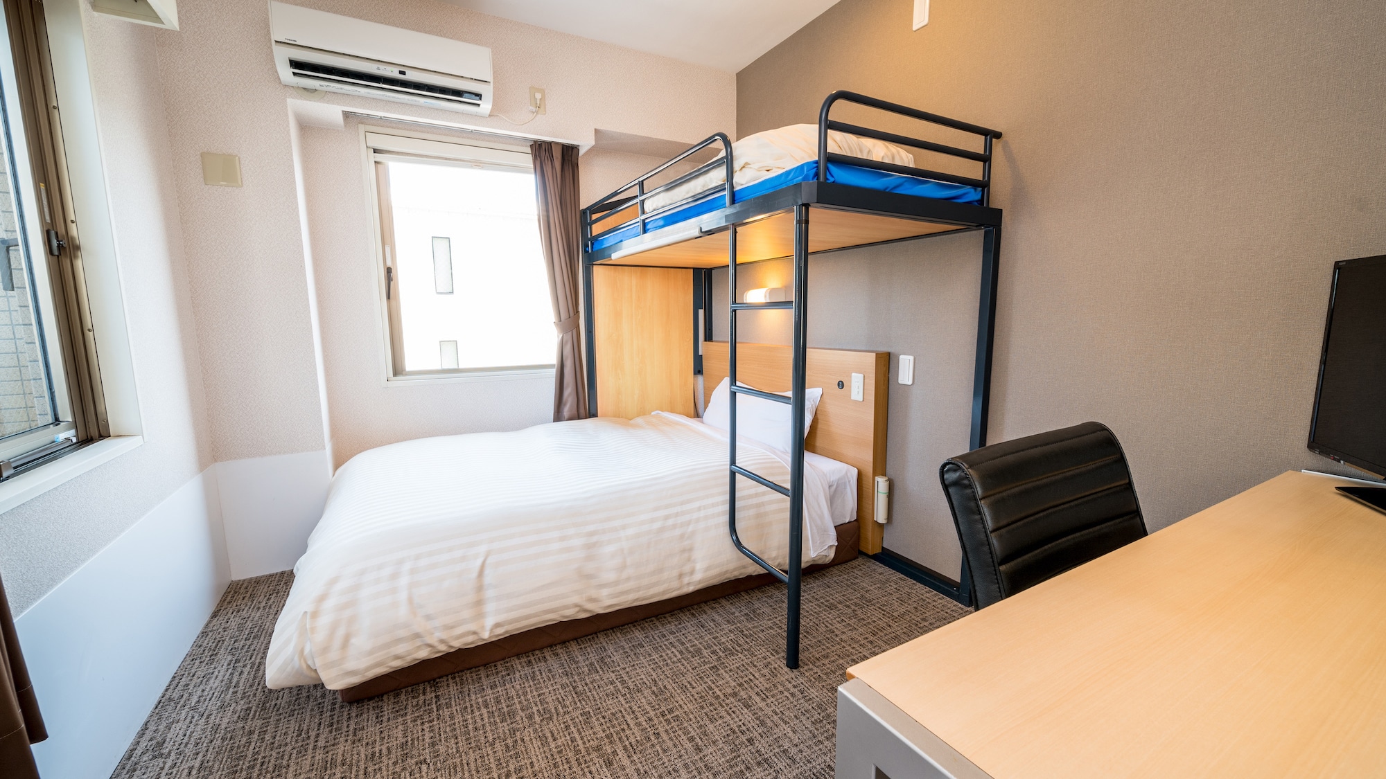 This room has a double bed and a loft bed.