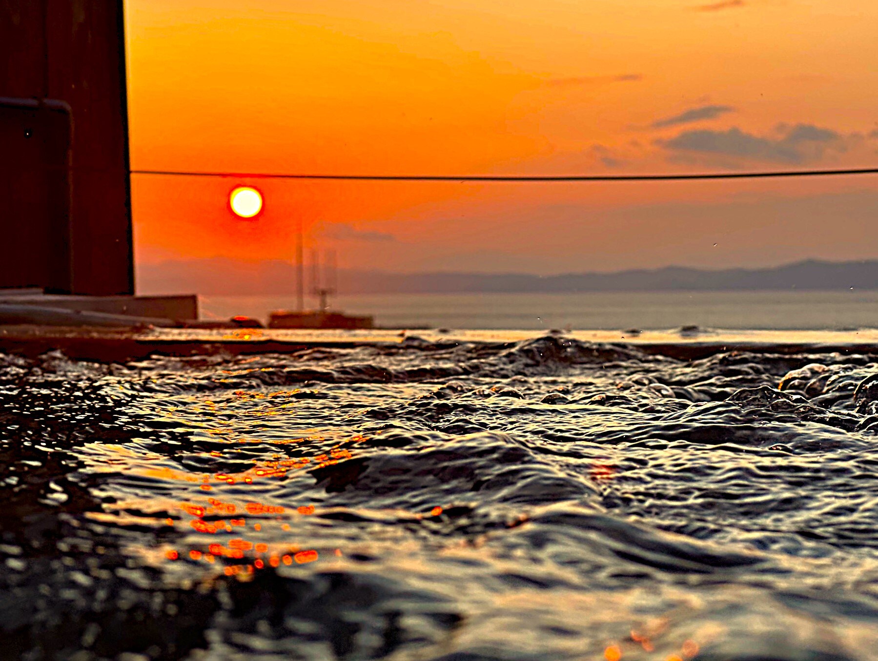[Sunset from the open-air rooftop bath]