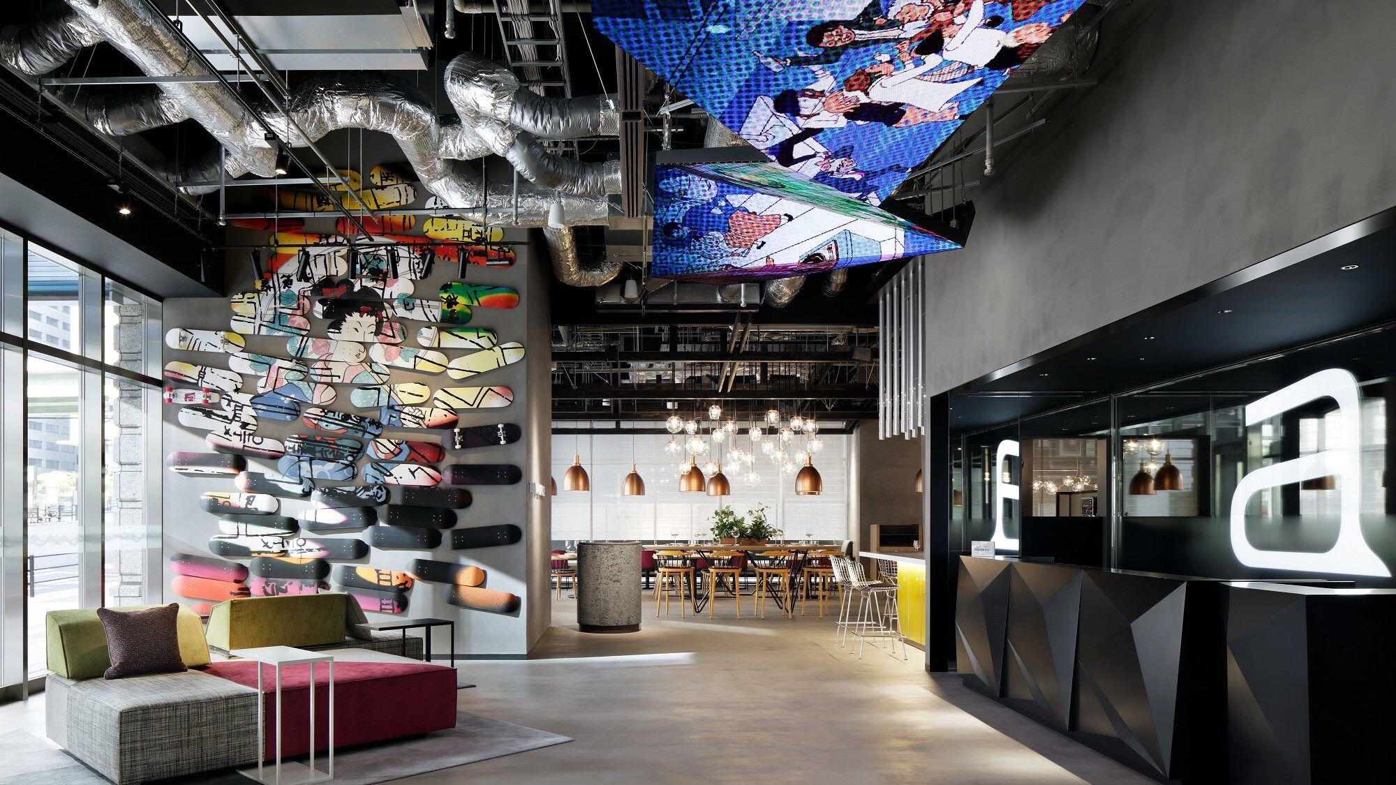 The lobby features wall art and innovative designs made up of colorfully painted skateboards.