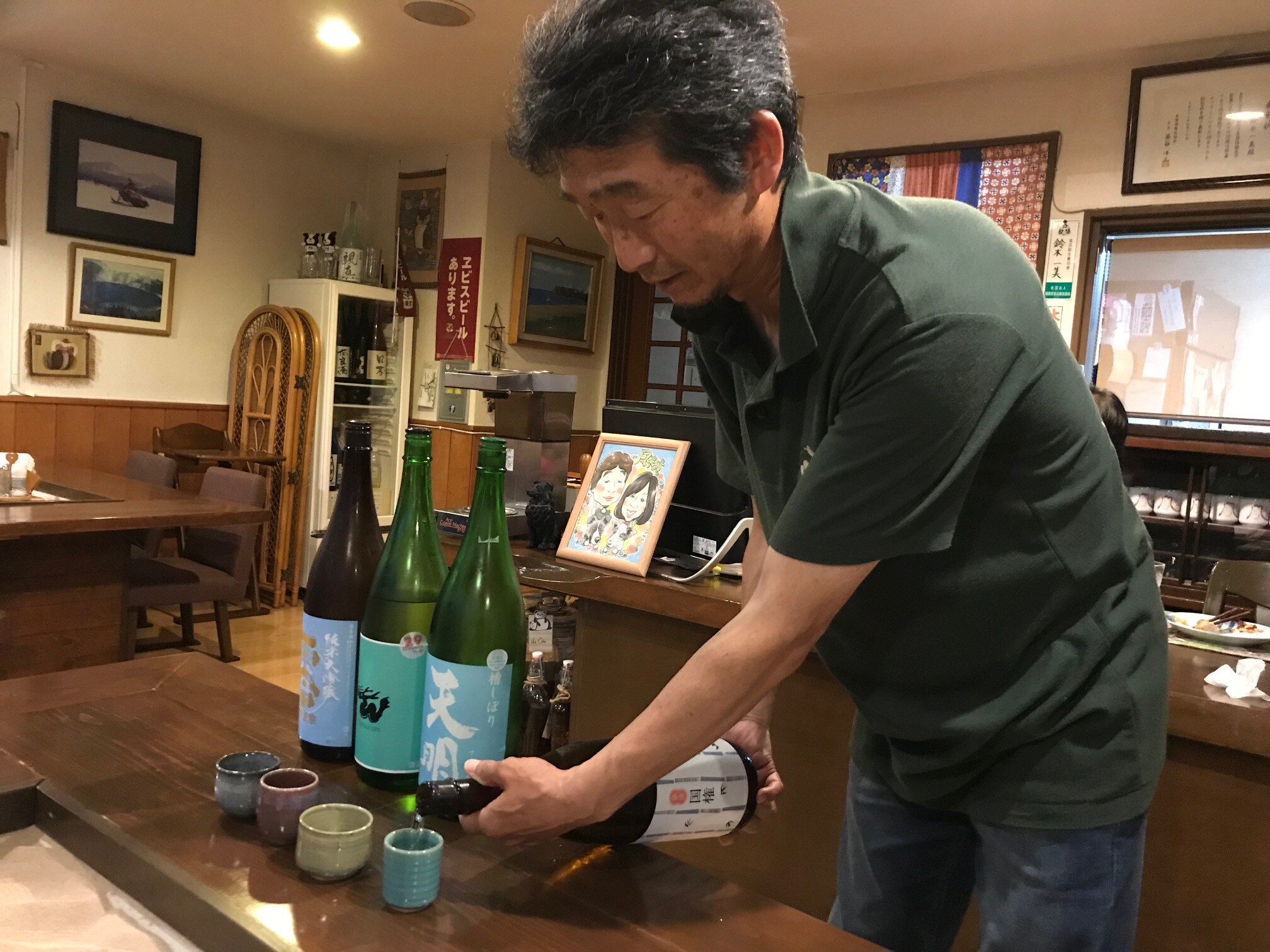 Pemiliknya menuangkannya ke dalam cangkir sake yang bergaya.