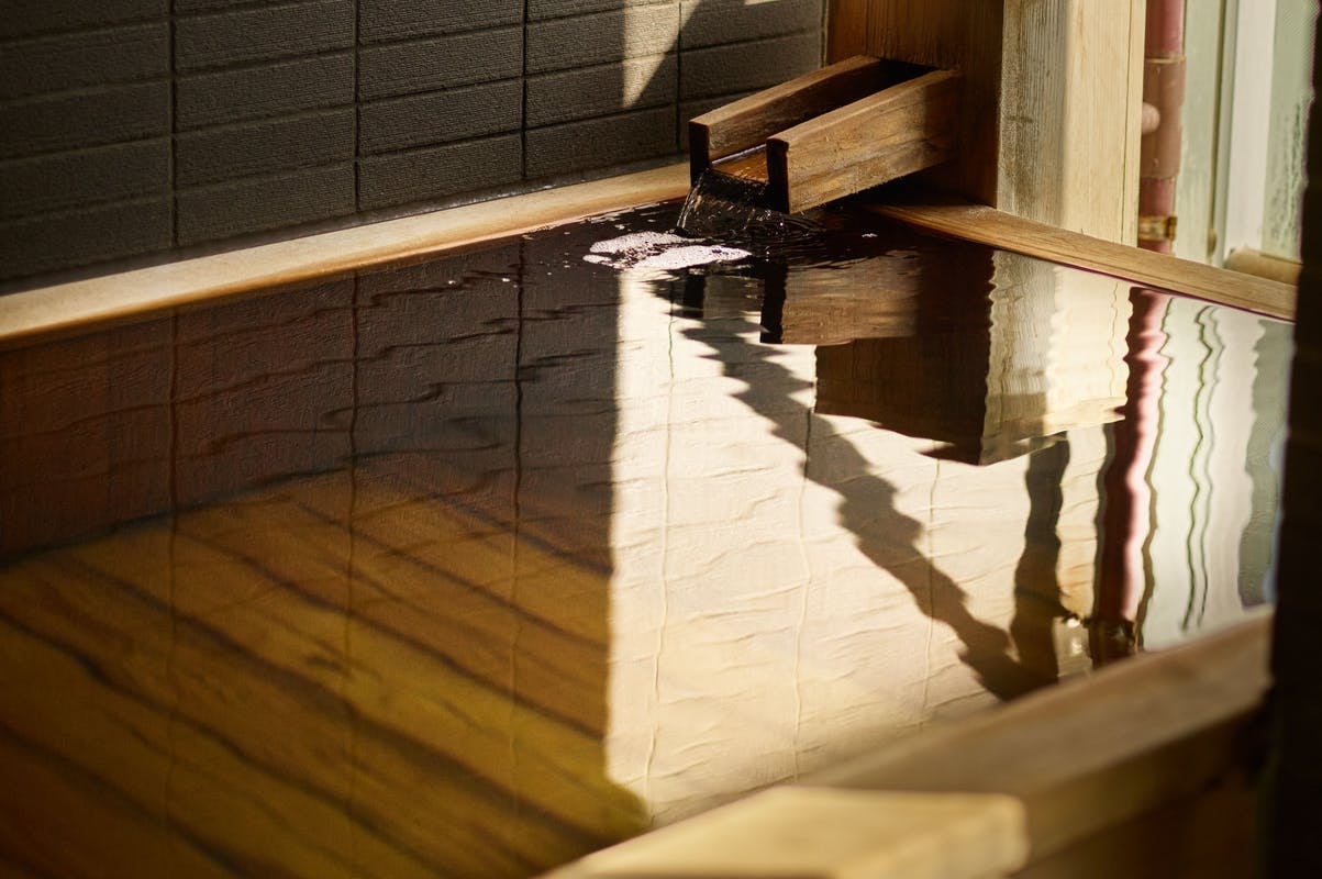 Premium room with cypress bath flowing from the source