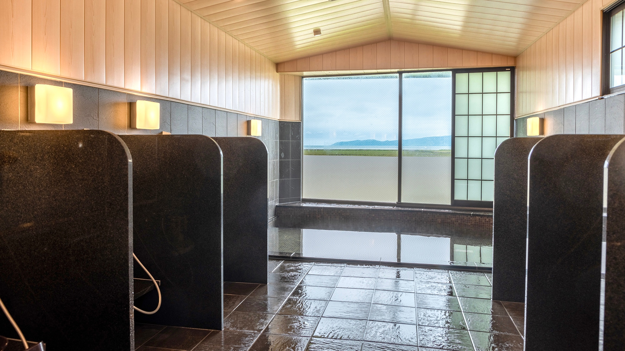 The newly renovated large public bath has large windows and an open feel.