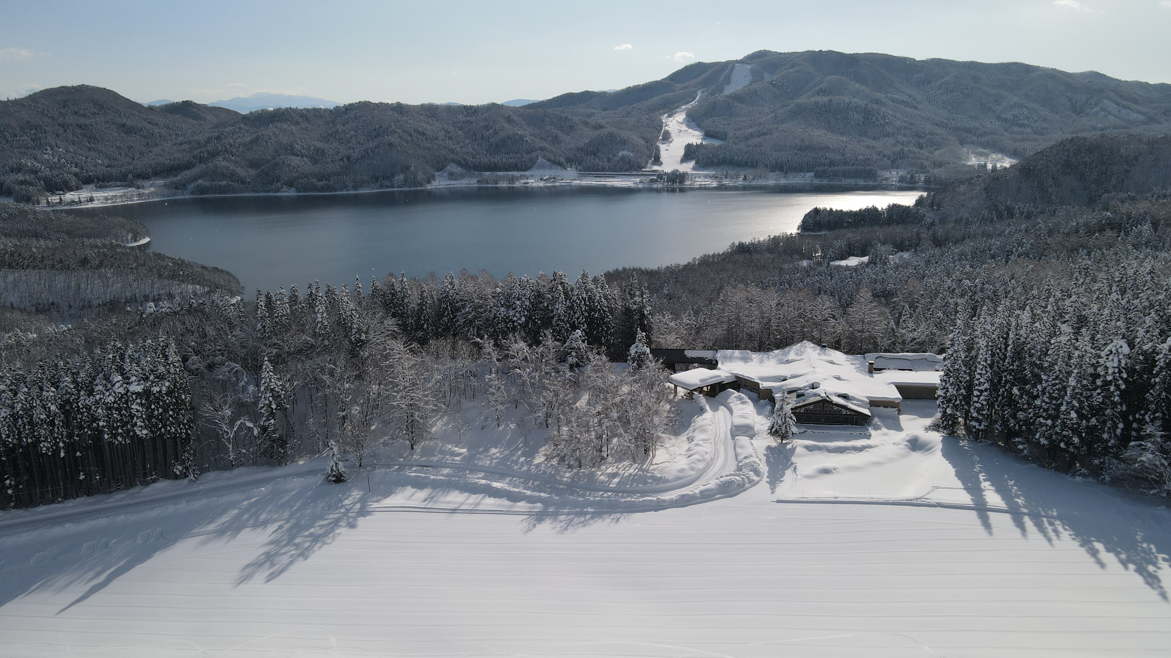 Winter exterior: A hotel sandwiched between Lake Aoki and Sanosaka Ski Resort