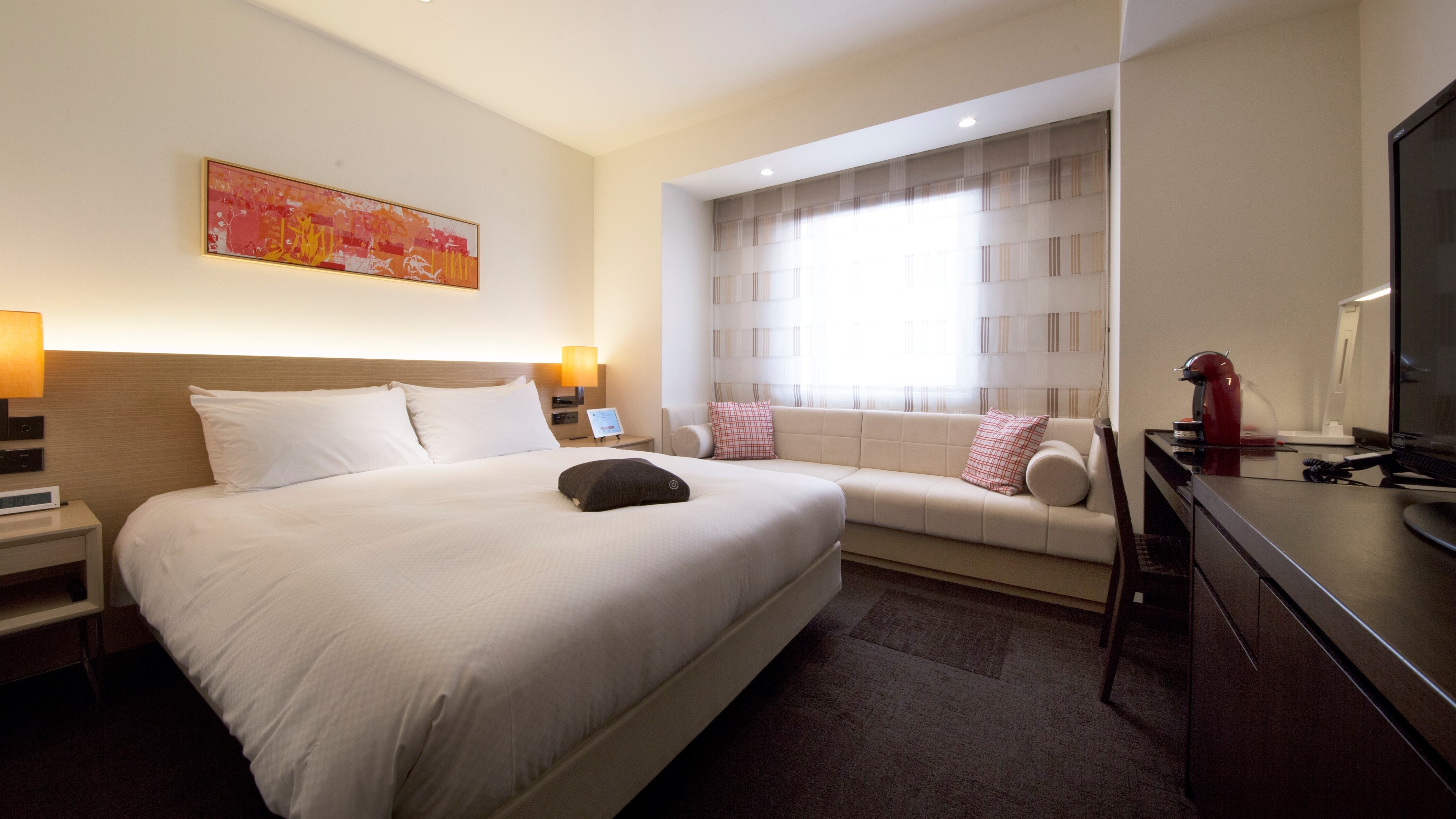 Relax in the "Deluxe Double" room featuring a sofa * The shape of the sofa varies depending on the room15
