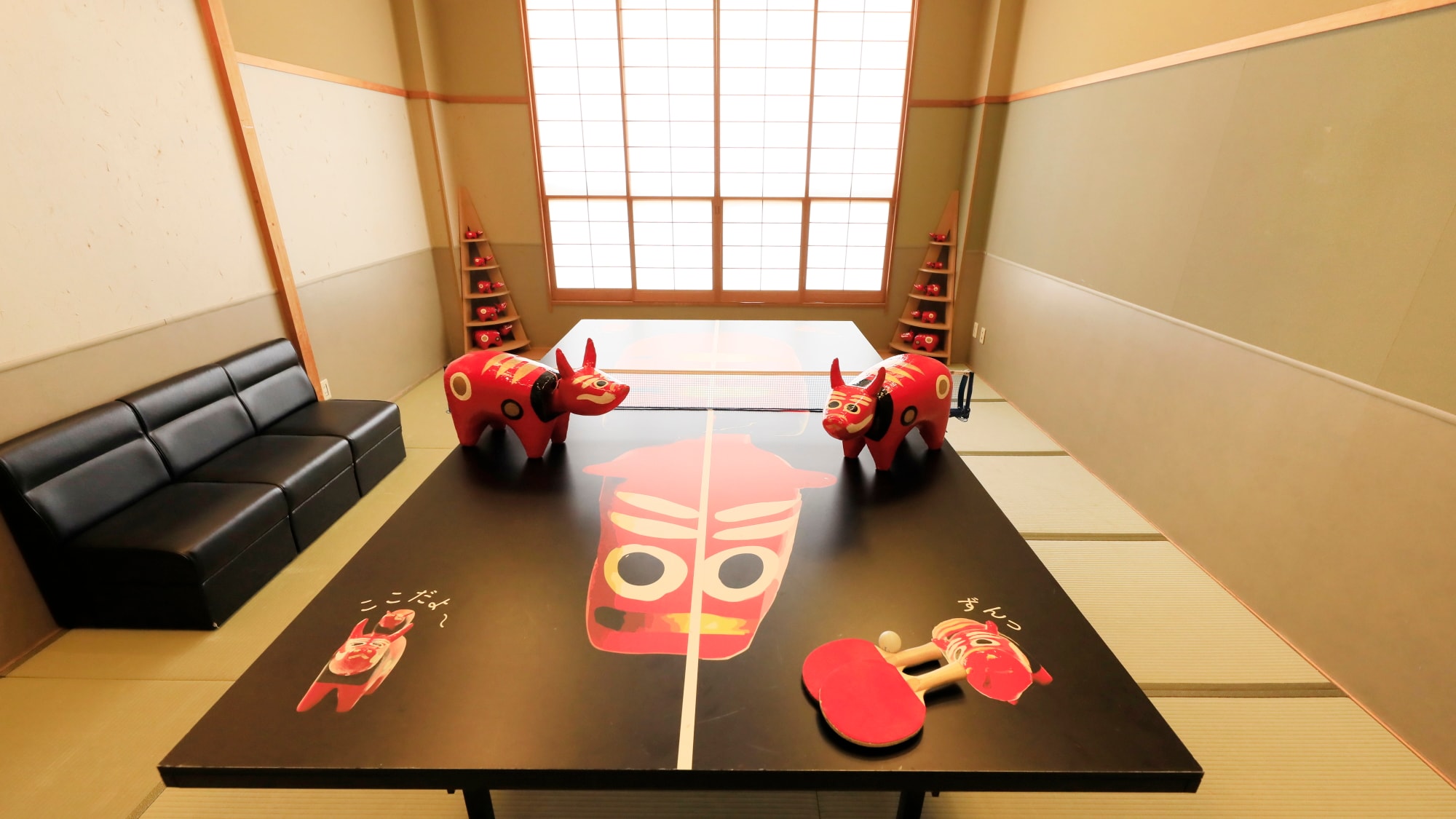 [Table Tennis Room] There is a big Akabeko on the table tennis table.