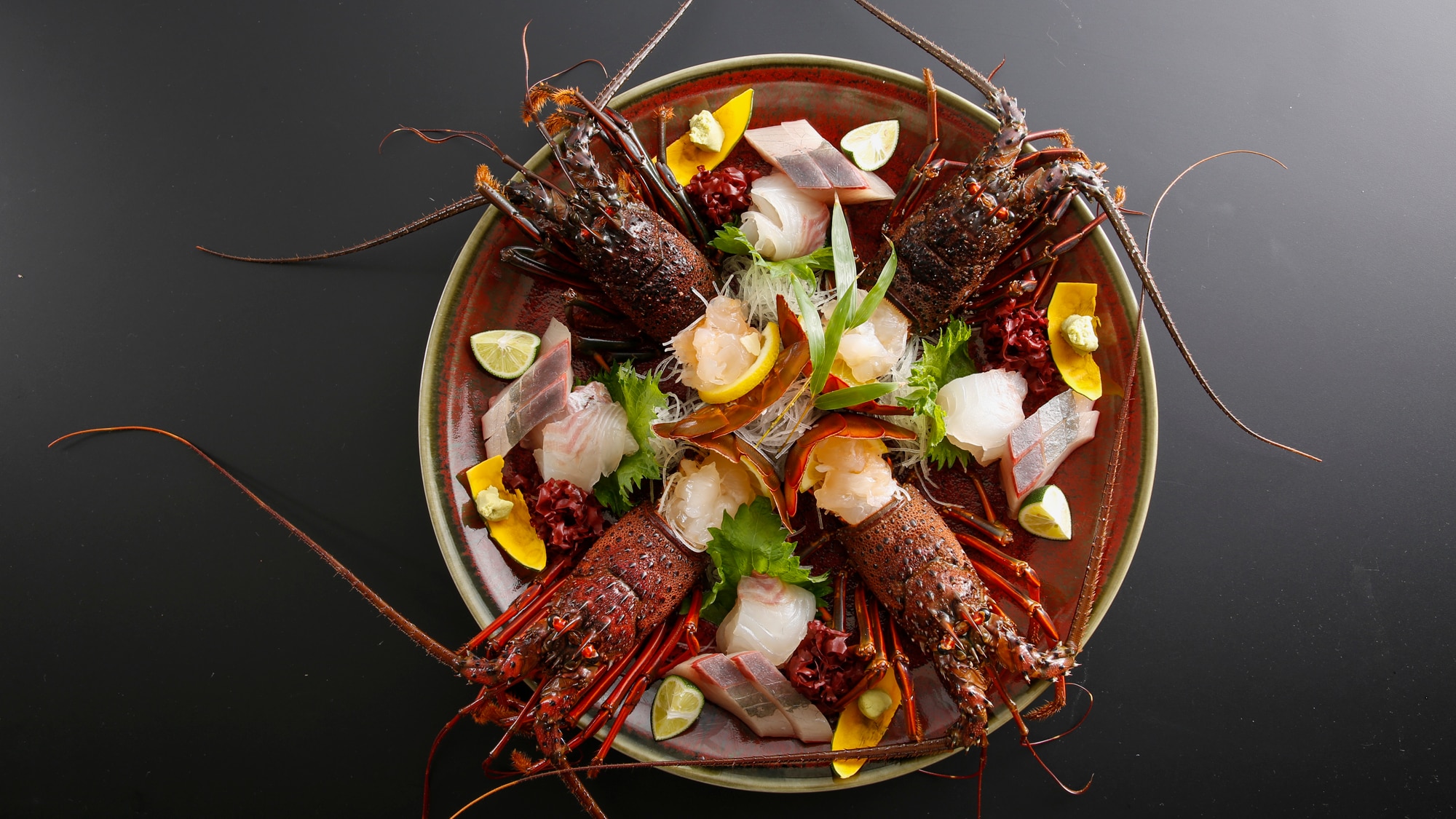 Sashimi of fresh spiny lobster, sea bream and amberjack. The photo is an image of 4 people.