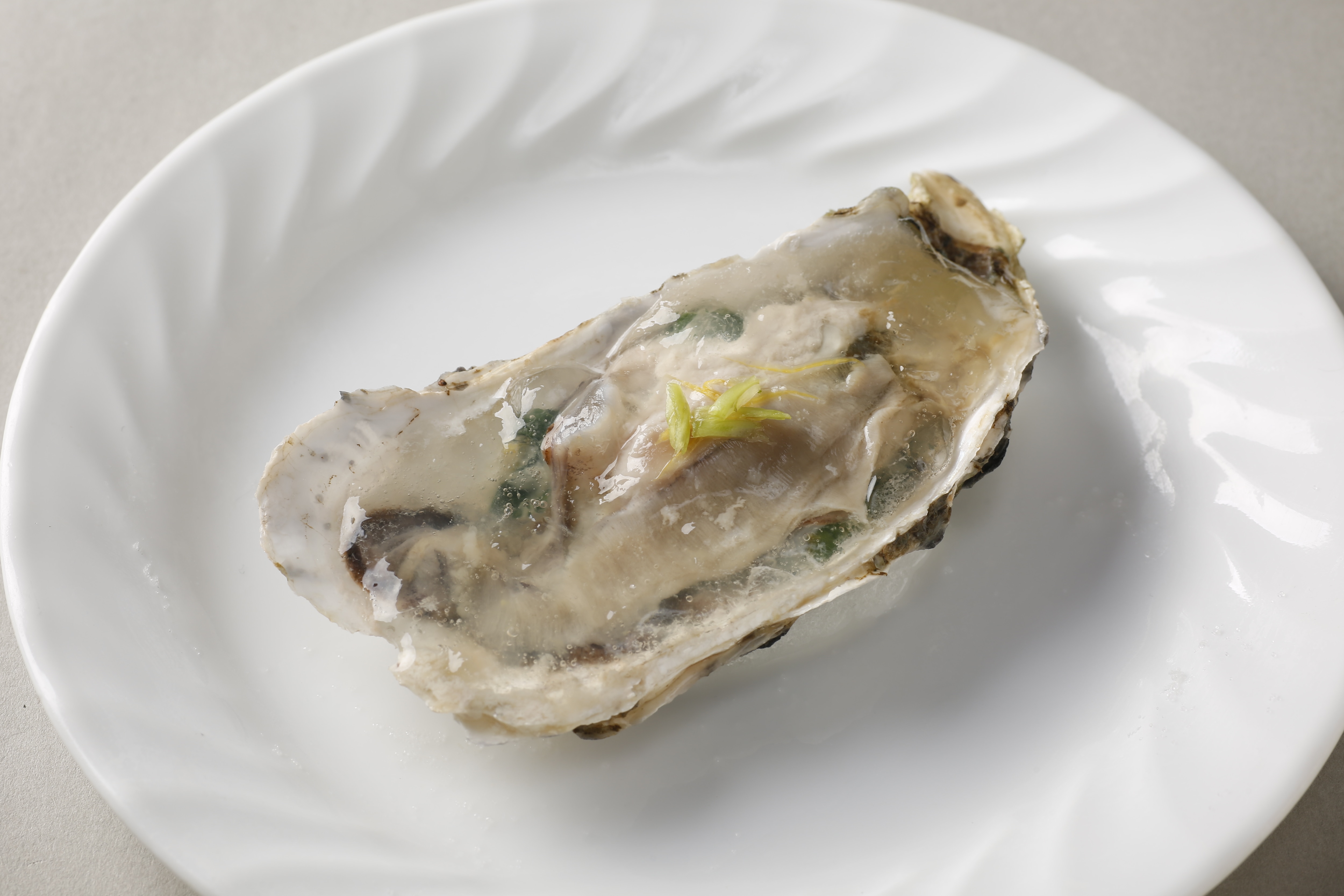 Oysters in shell from Miyajima, Hiroshima, steamed at low temperature with lime jelly