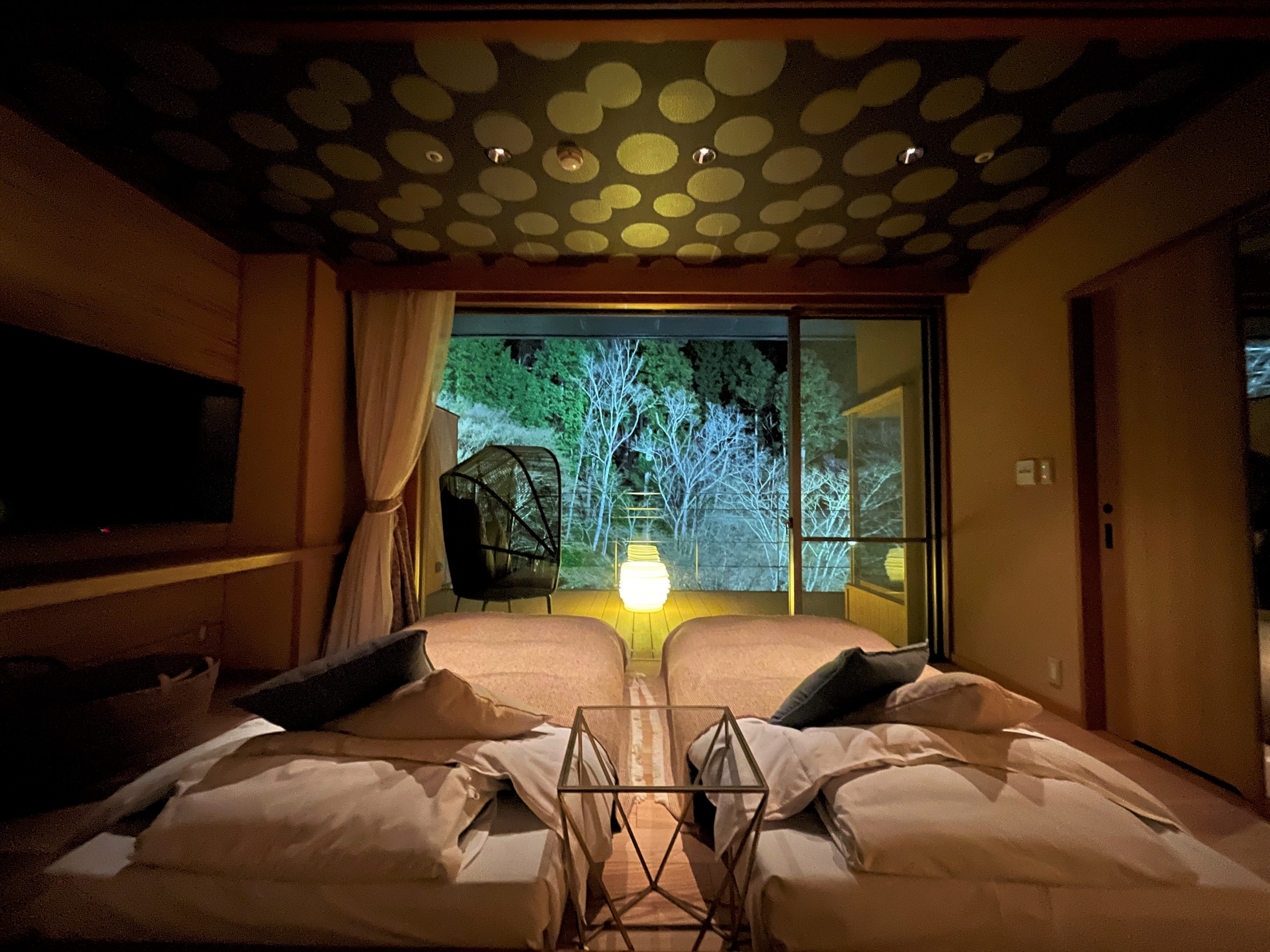 Semi-open-air hot spring & terrace + garden with Japanese bed Illuminated from the guest room (image)