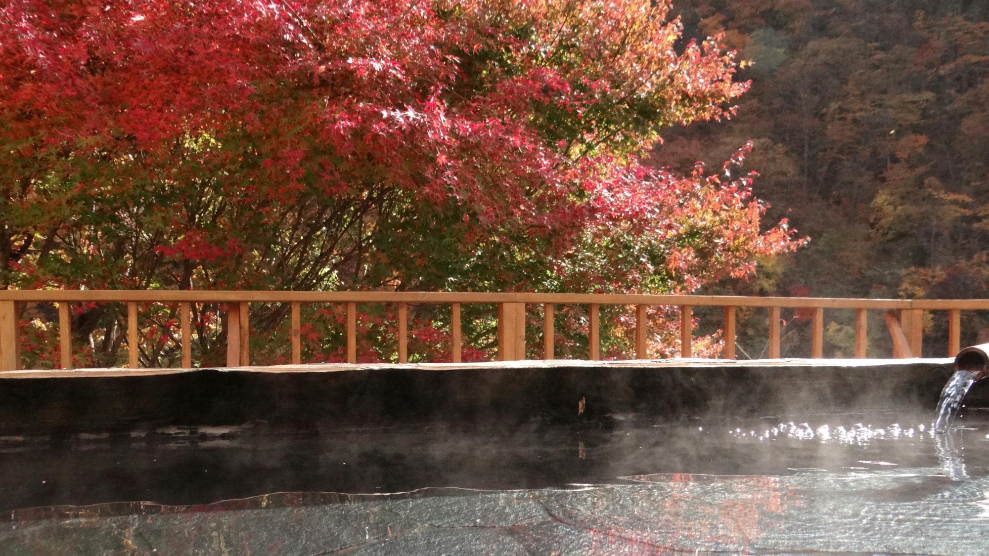 [View from the open-air bath (Autumn)] The colorful mountains along the valley
