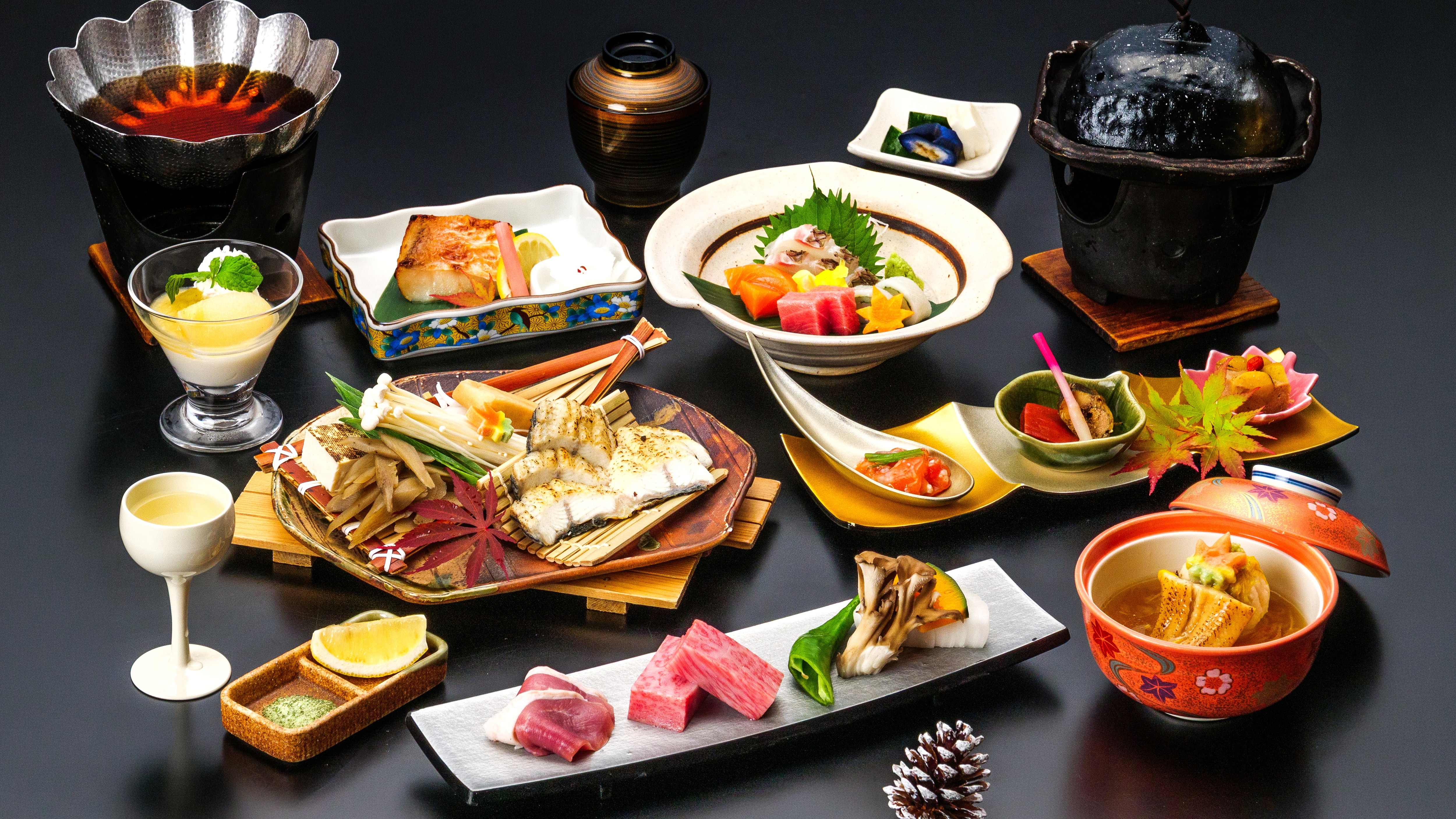 Hidangan kaiseki musiman yang menampilkan belut yang direbus dalam saus gurih dan daging sapi Omi yang dipanggang di atas piring keramik (dengan tema musim gugur).