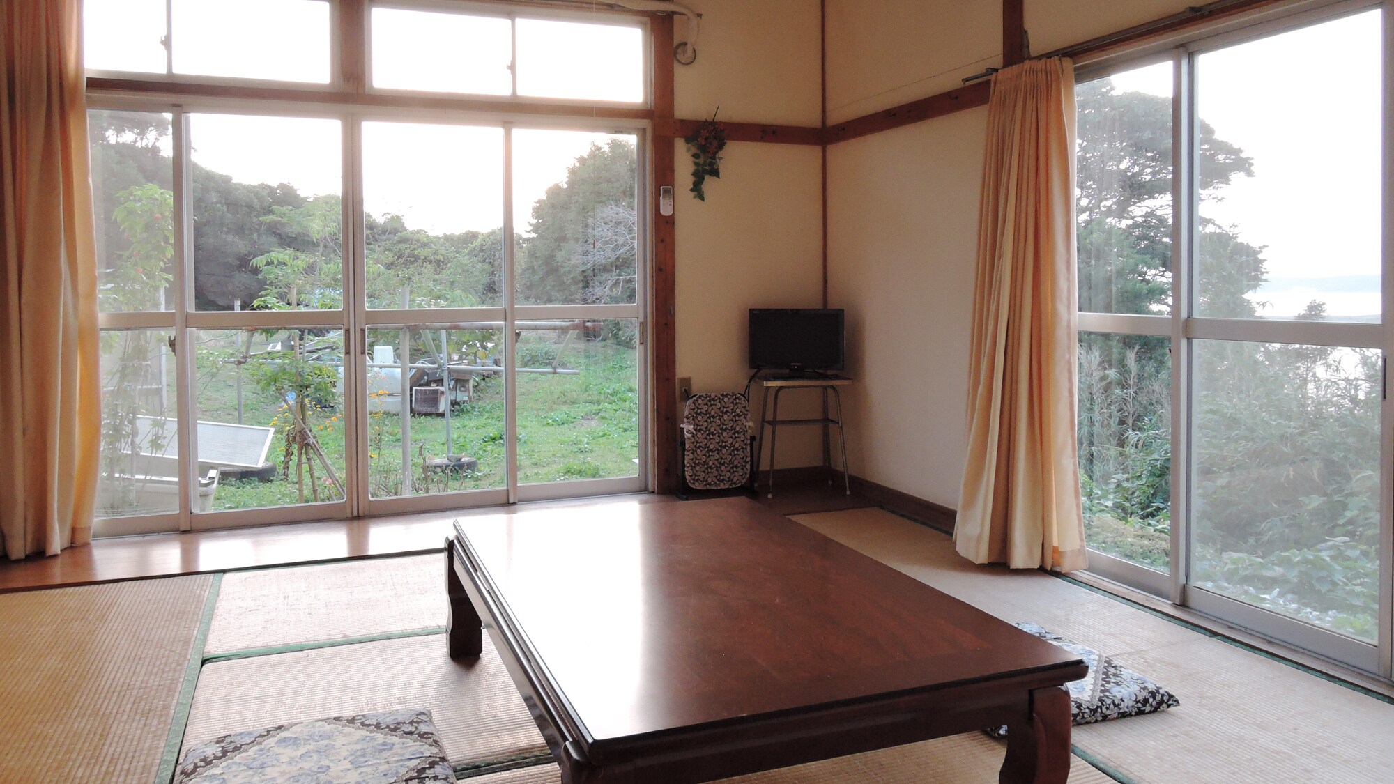 * One guest room (Room 10): Bright sunlight shines through the large windows.