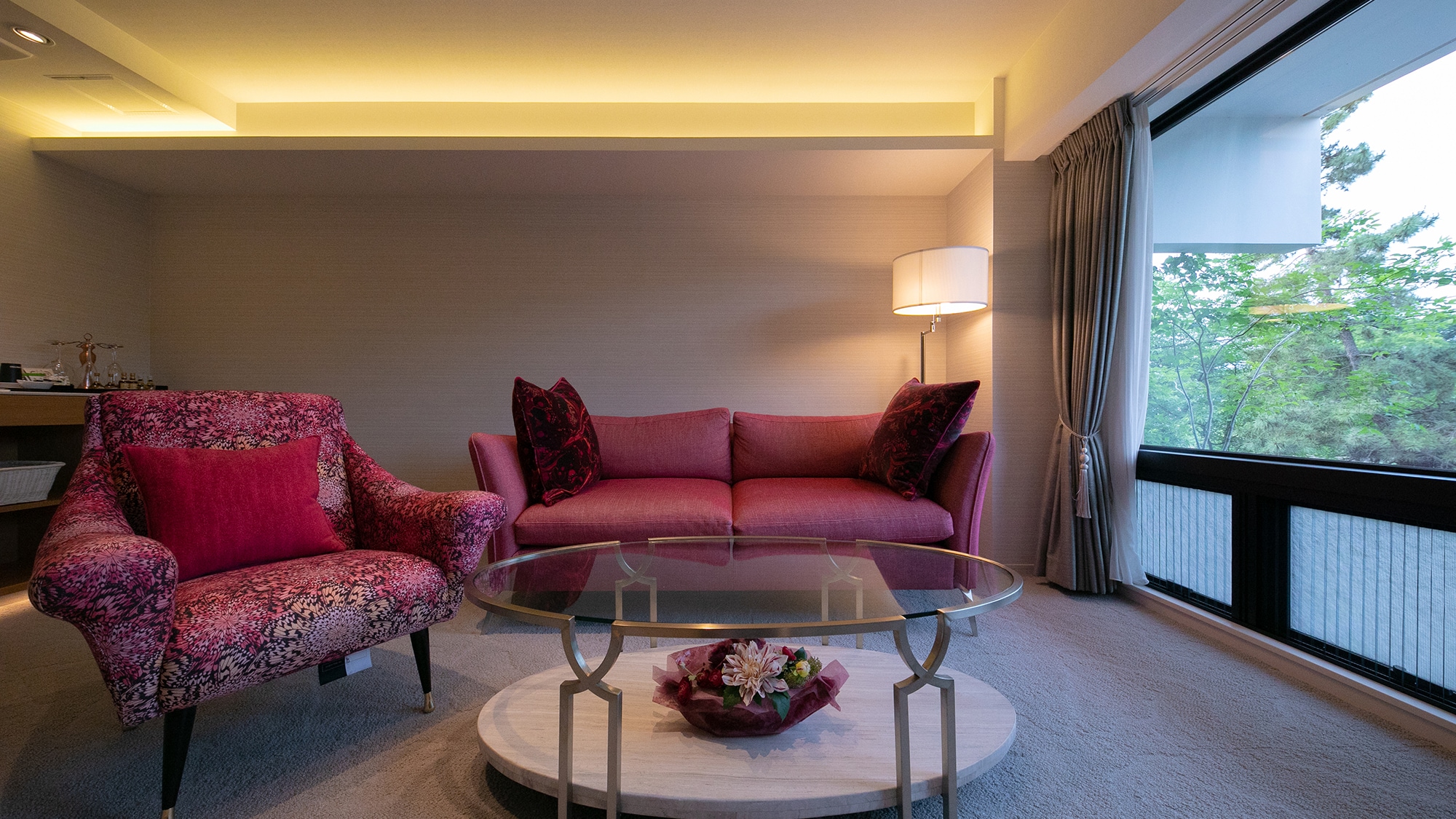 "Moderate Twin A" A bright pink and wine red sofa and a champagne gold center table.