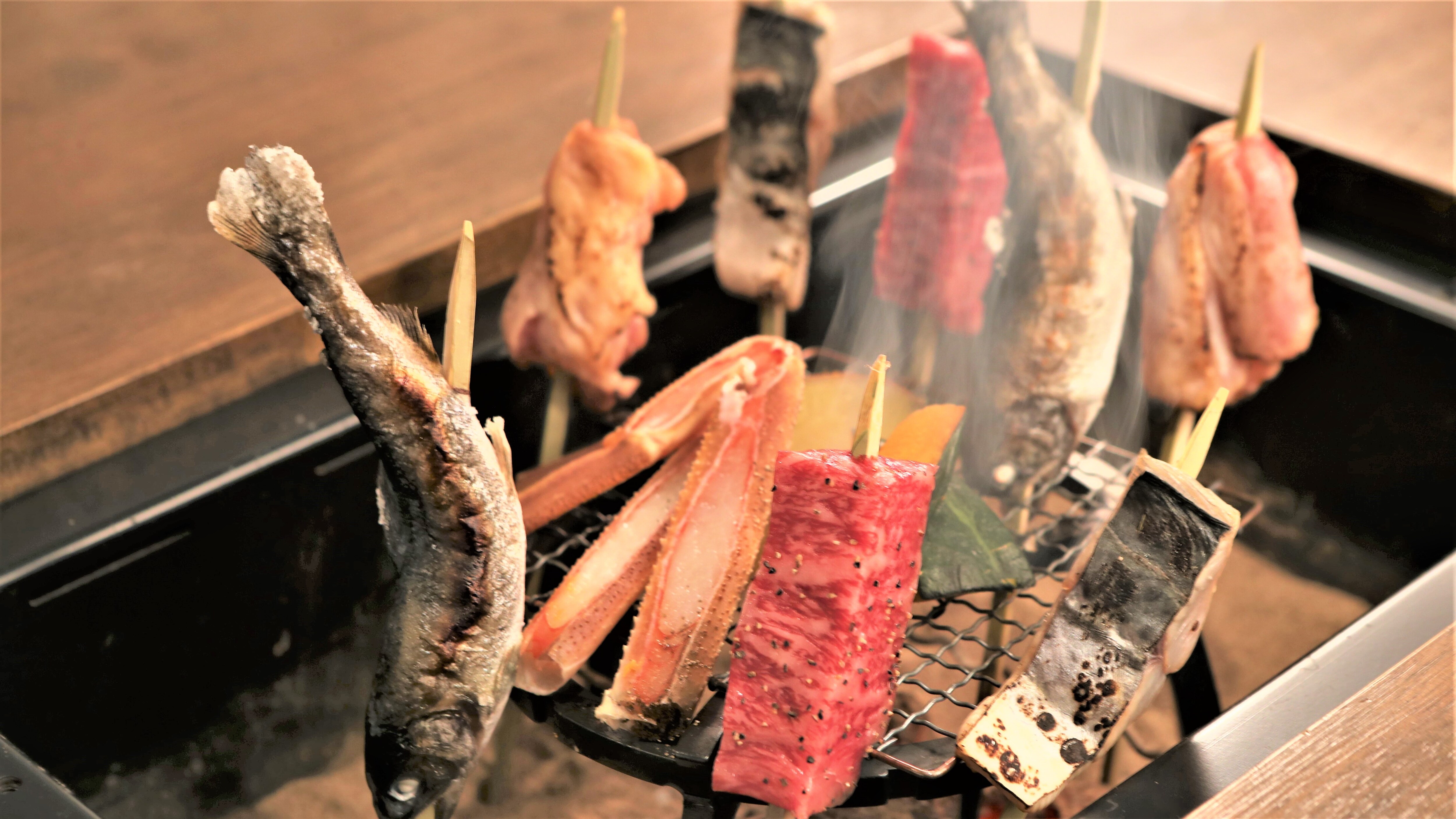 Enjoy grilled seasonal ingredients around the hearth at each table.