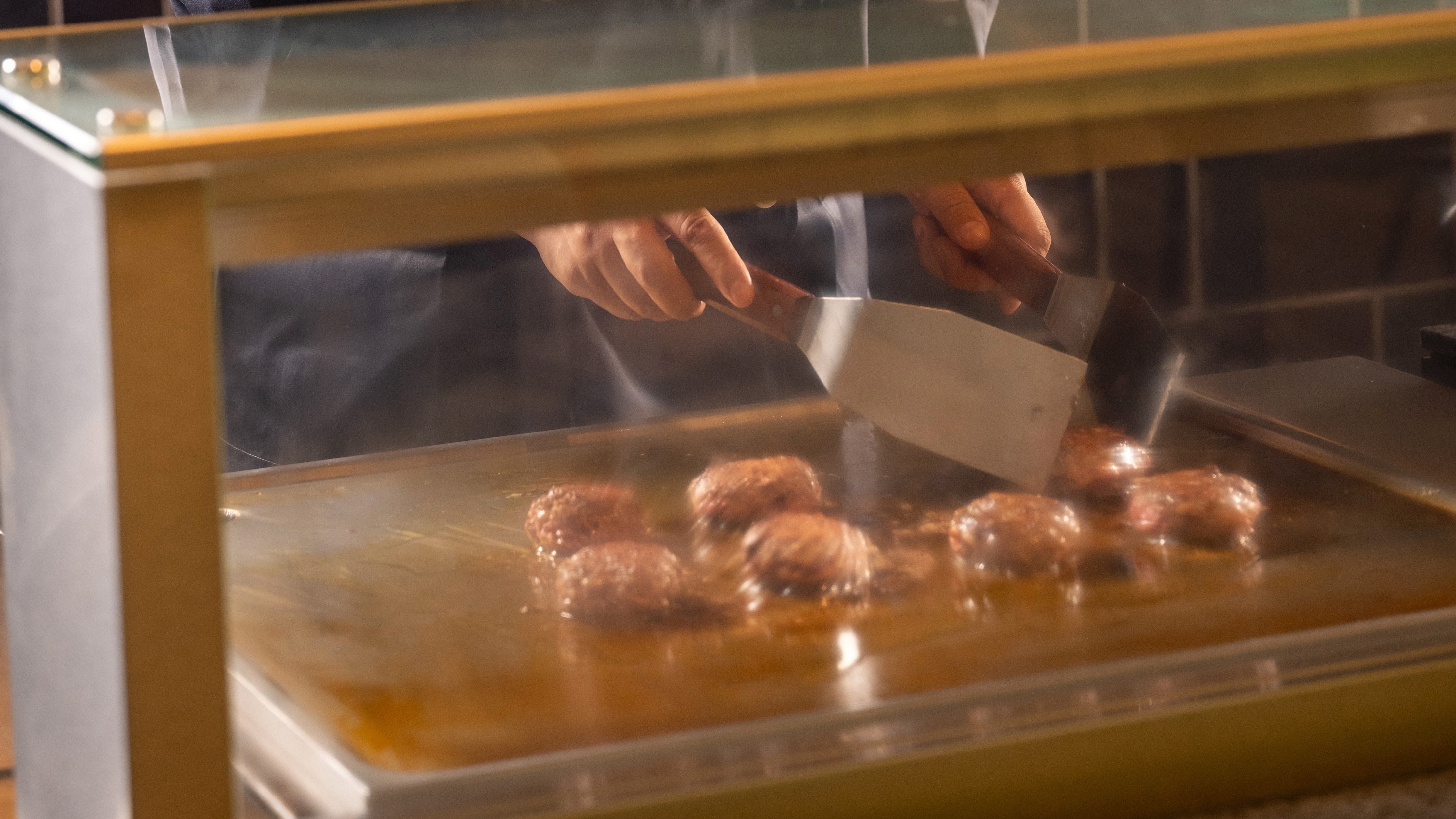 Homemade hamburger steak made with Noto beef and Noto pork prepared in the live kitchen *Image shown