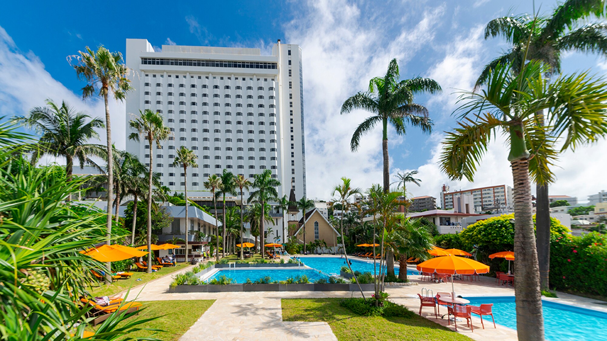 【夏日花園泳池】那霸市最大的室外泳池之一，周圍環繞著棕櫚樹和綠色植物！