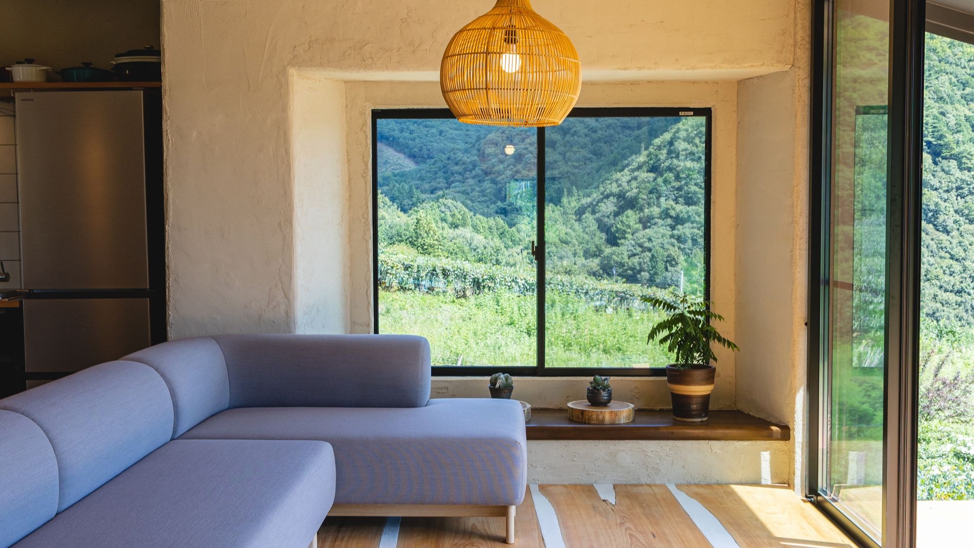 A living room with a view of Mt. Fuji and the countryside