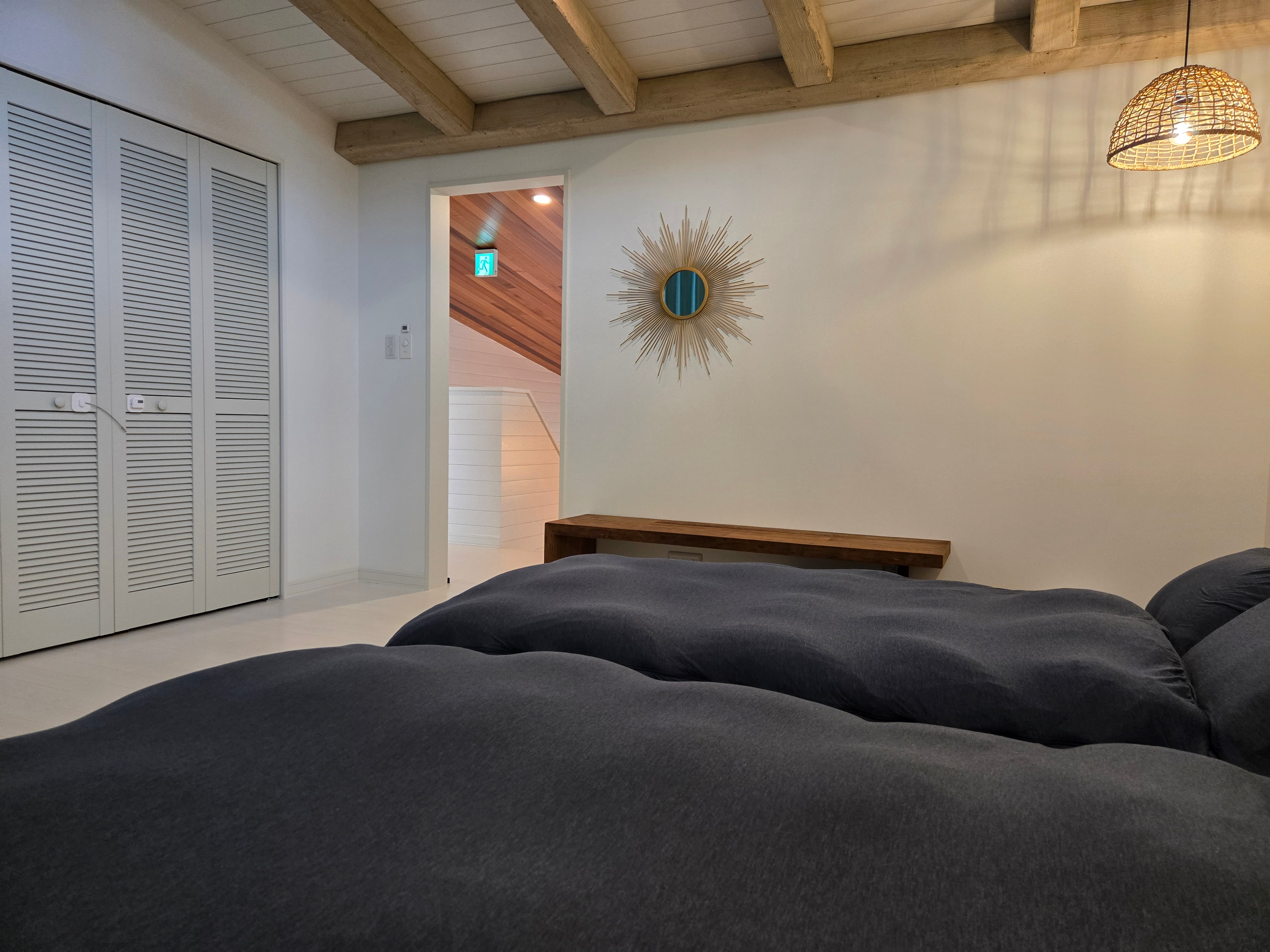 A tranquil bedroom with a wood accent wall.