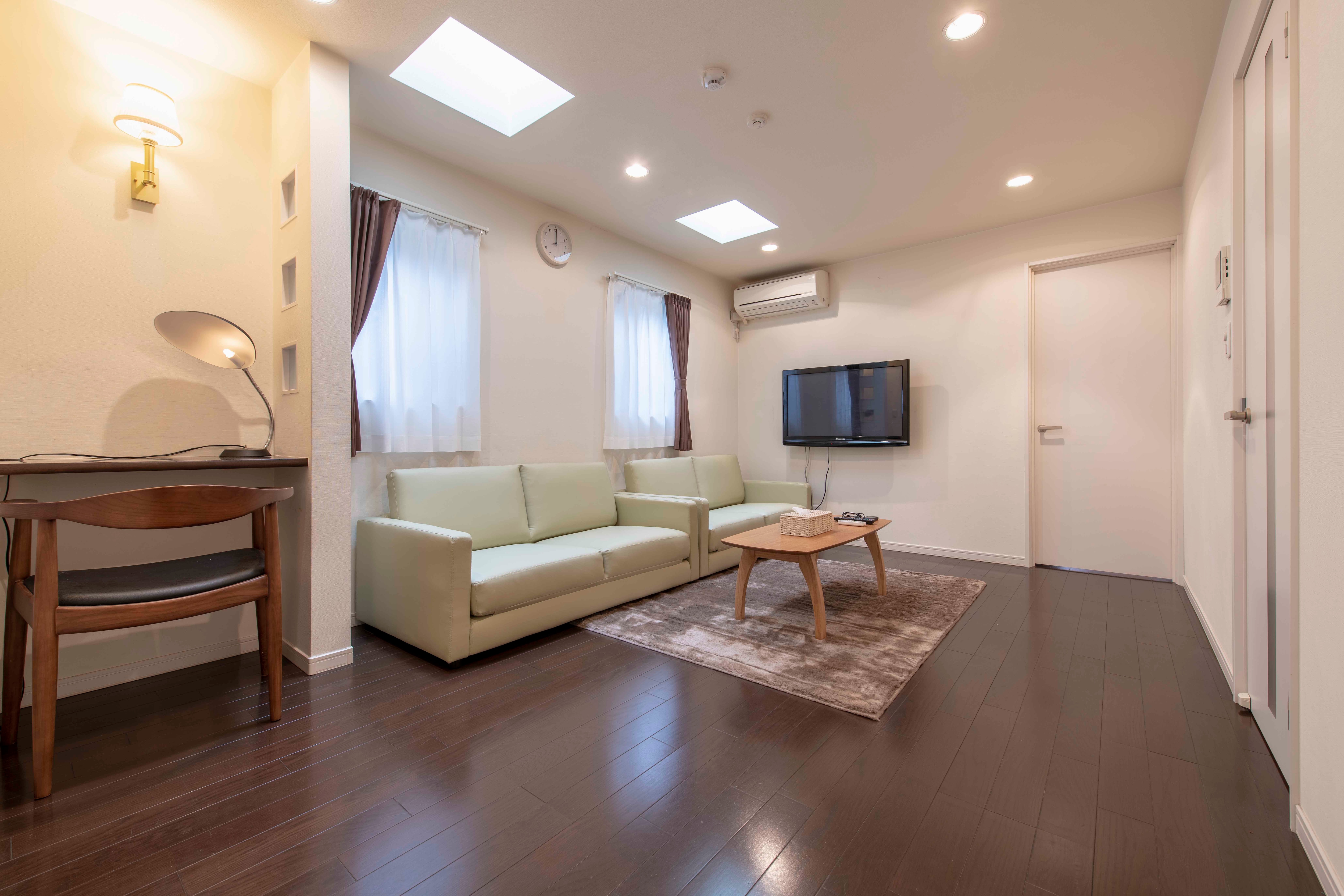 The spacious living/dining room is separated from the bedroom for a comfortable stay.