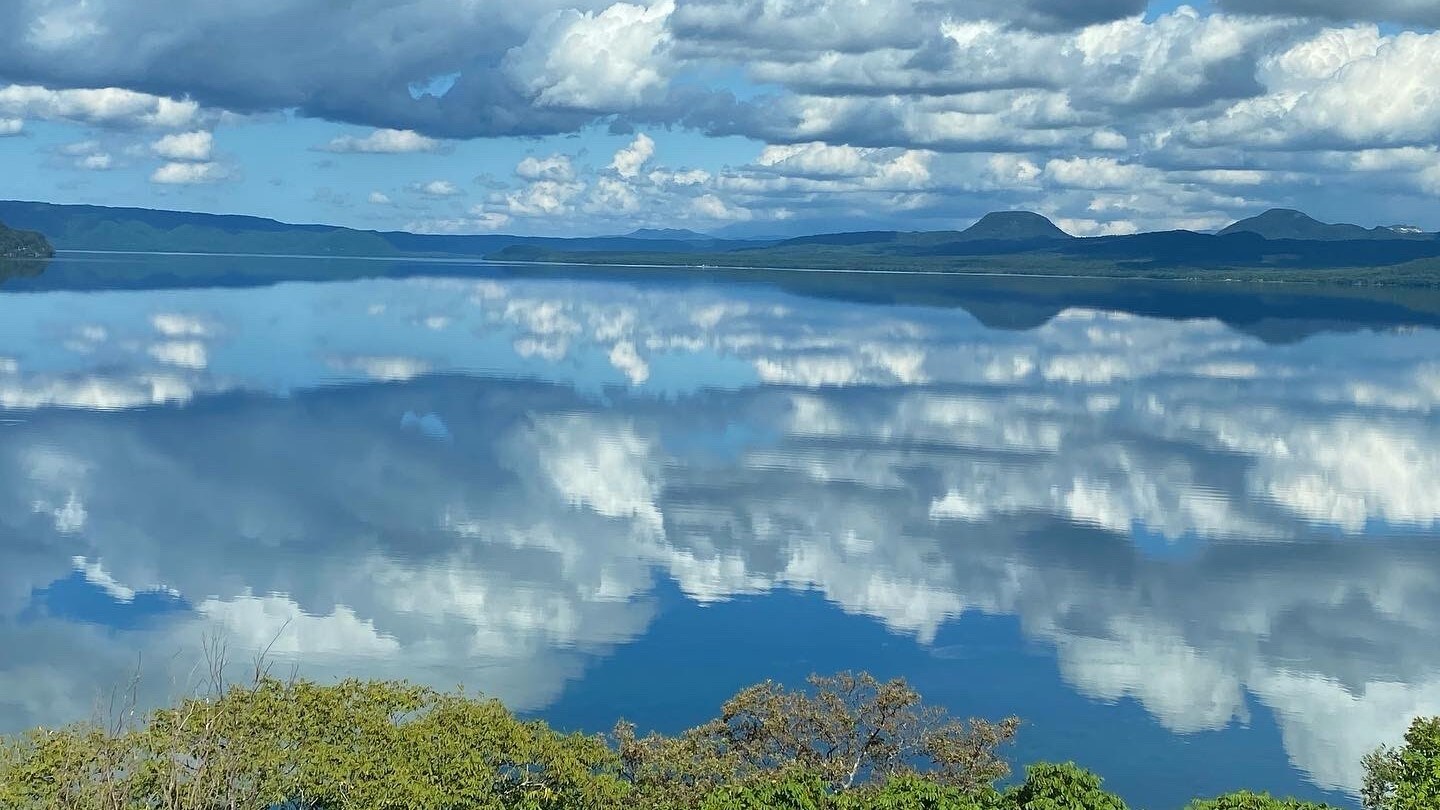 On a windless, sunny day, Lake Kussharo reflects the sky like a mirror.