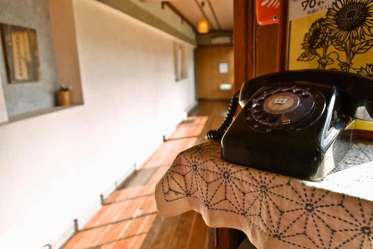 The internal line is an old-fashioned black telephone.