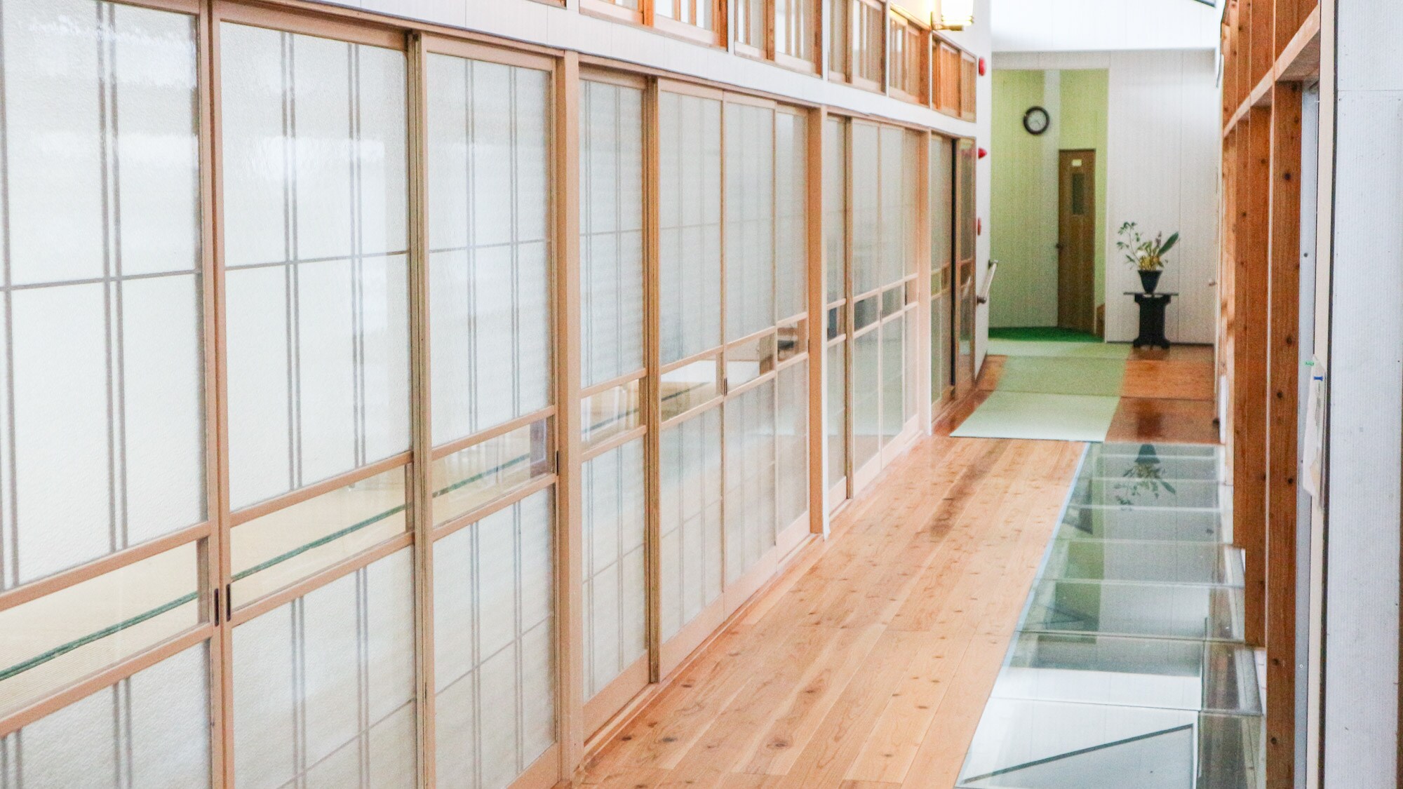*[Example inside the building] A unique corridor where you can see koi swimming underneath the glass floor.