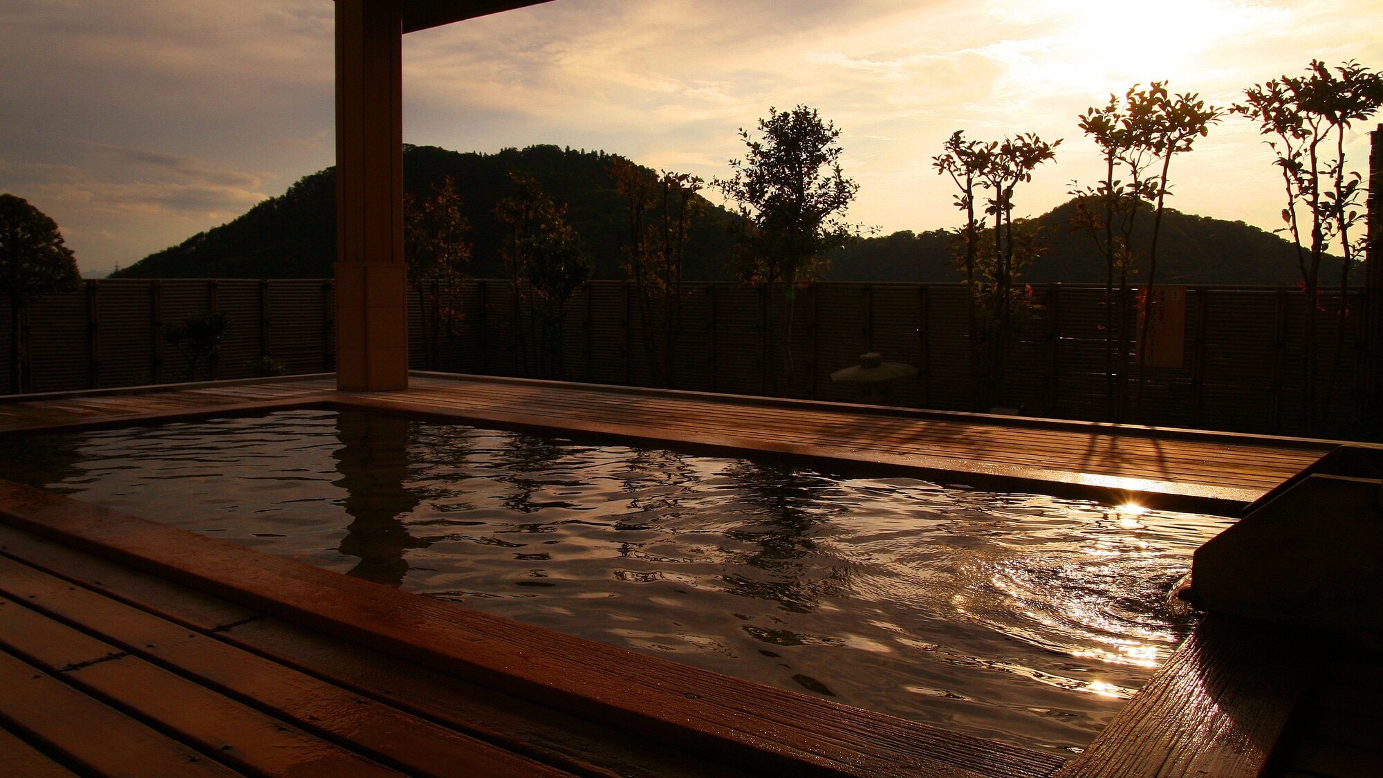 The bath's surface is dyed in the setting sun, soothing to the soul.