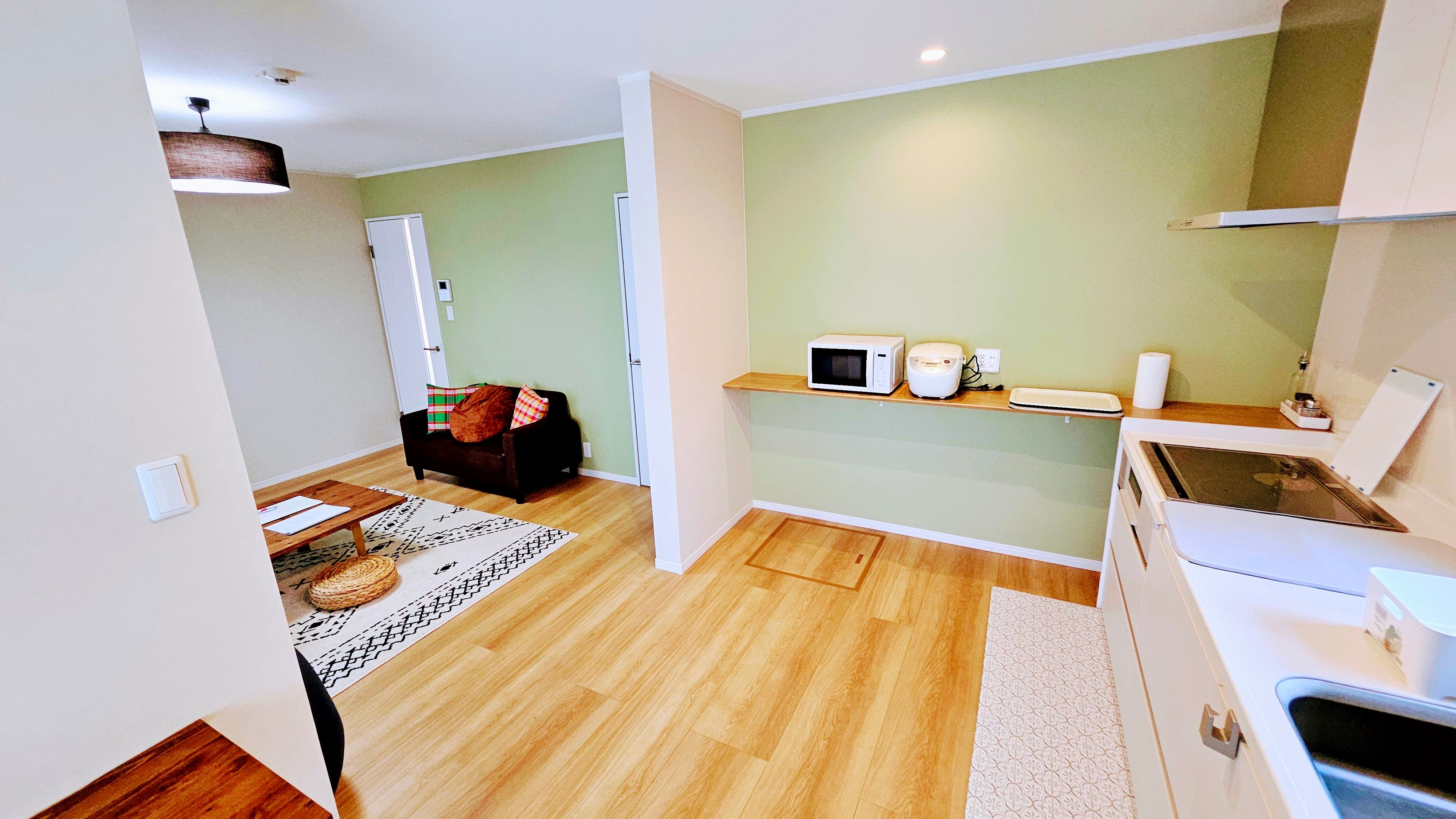 Main House Kitchen: Spacious worktop and induction stove, refrigerator, microwave, cookware and tableware