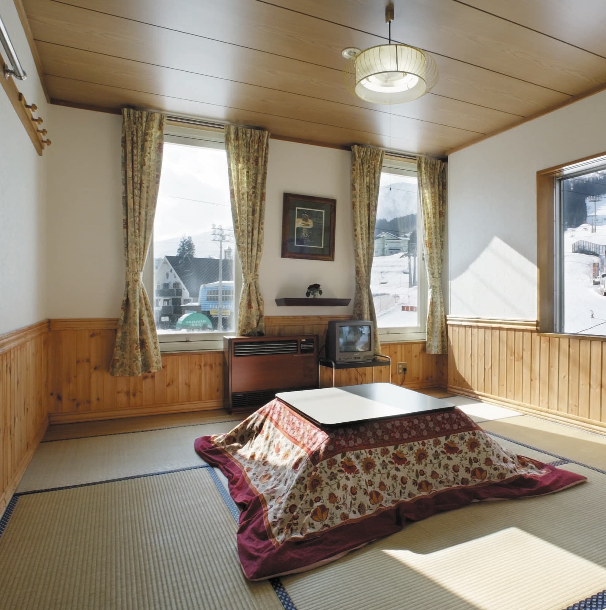 A Japanese-style room with 8 tatami mats and a view of the slopes and night skiing.