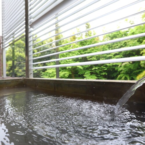 Enjoy the view of greenery from the open-air bath in your room.