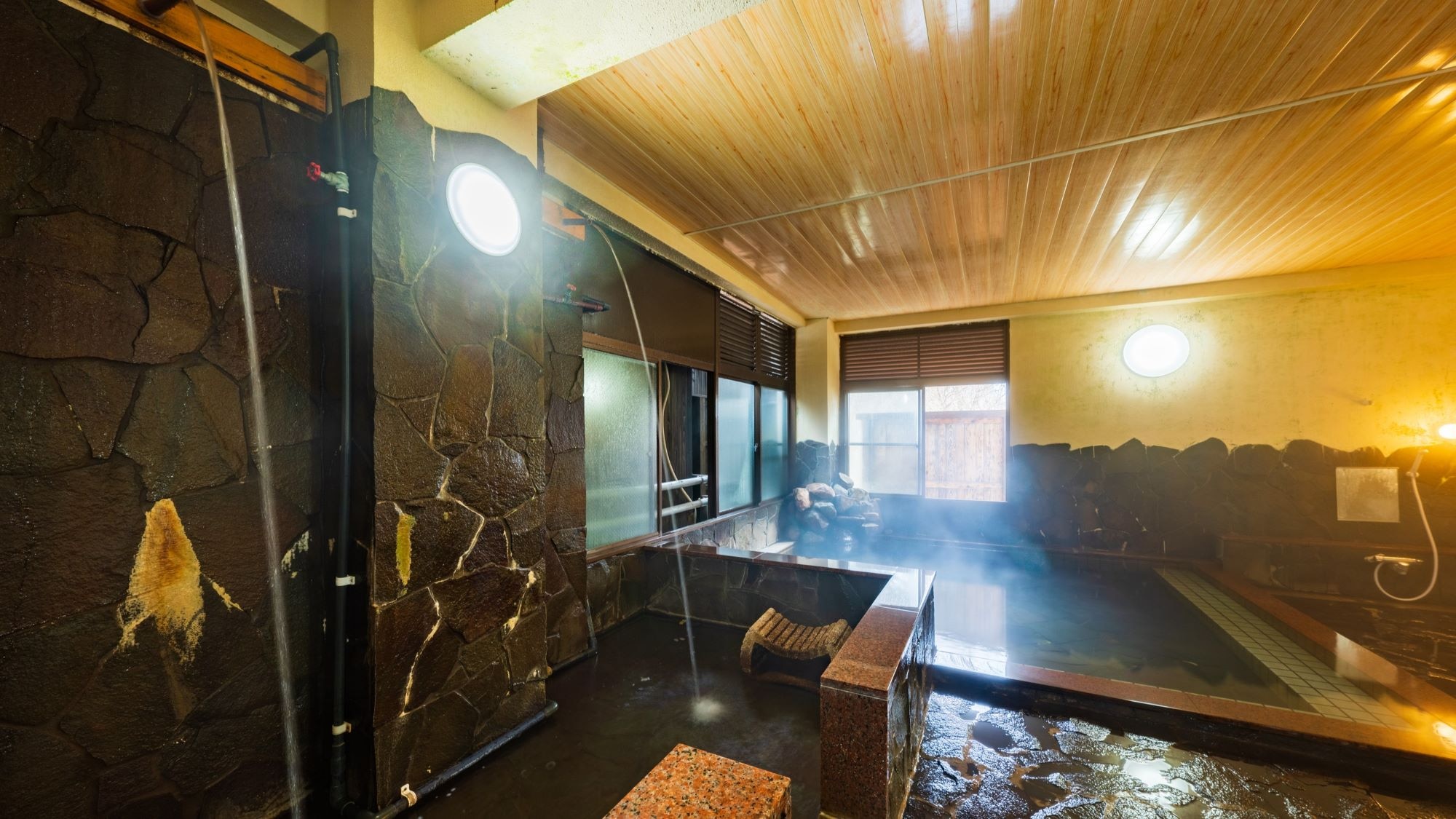 Large public bath: Women's bath / Example. The women's bath has a waterfall bath.