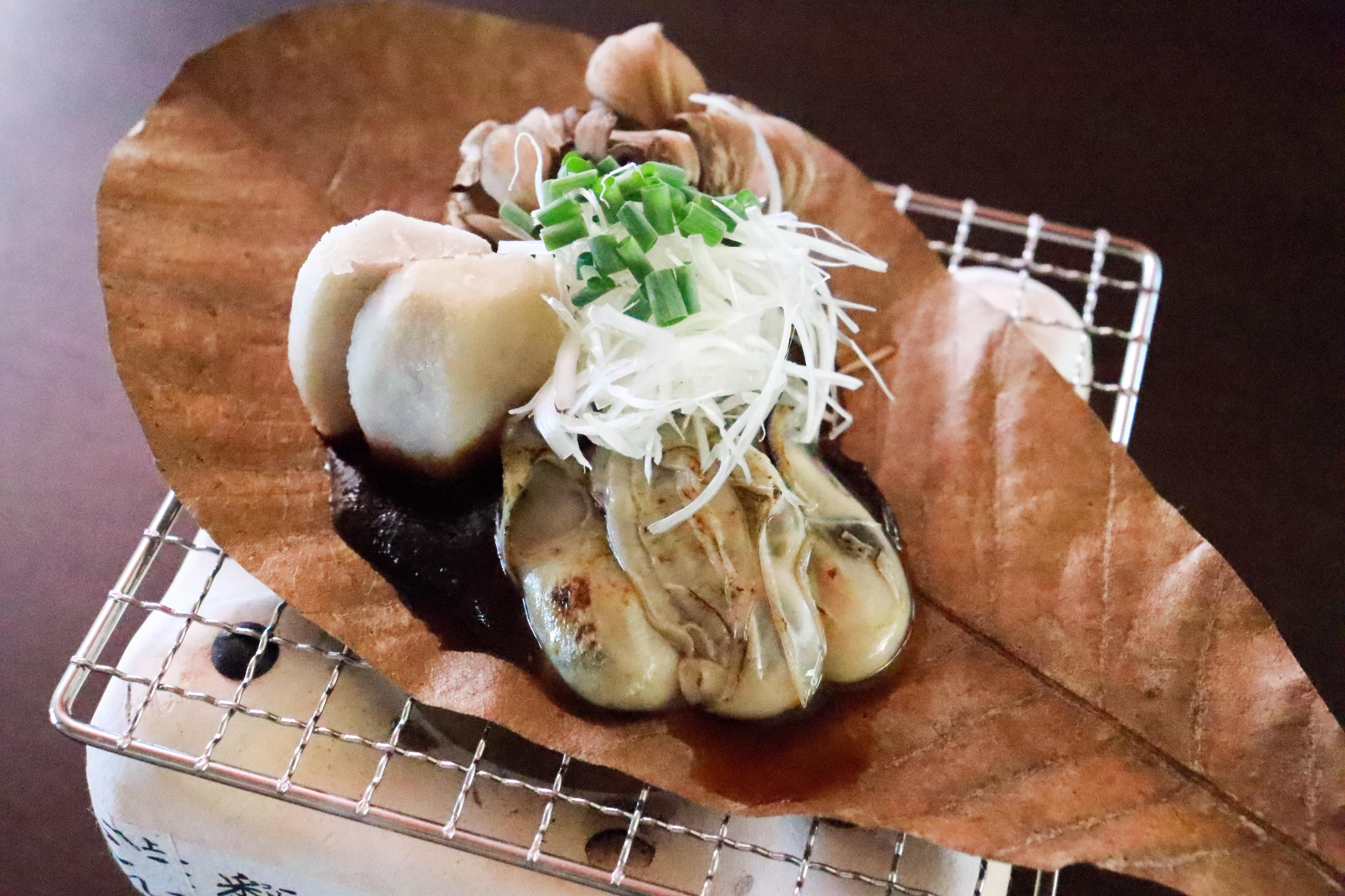 Oysters grilled on magnolia leaves