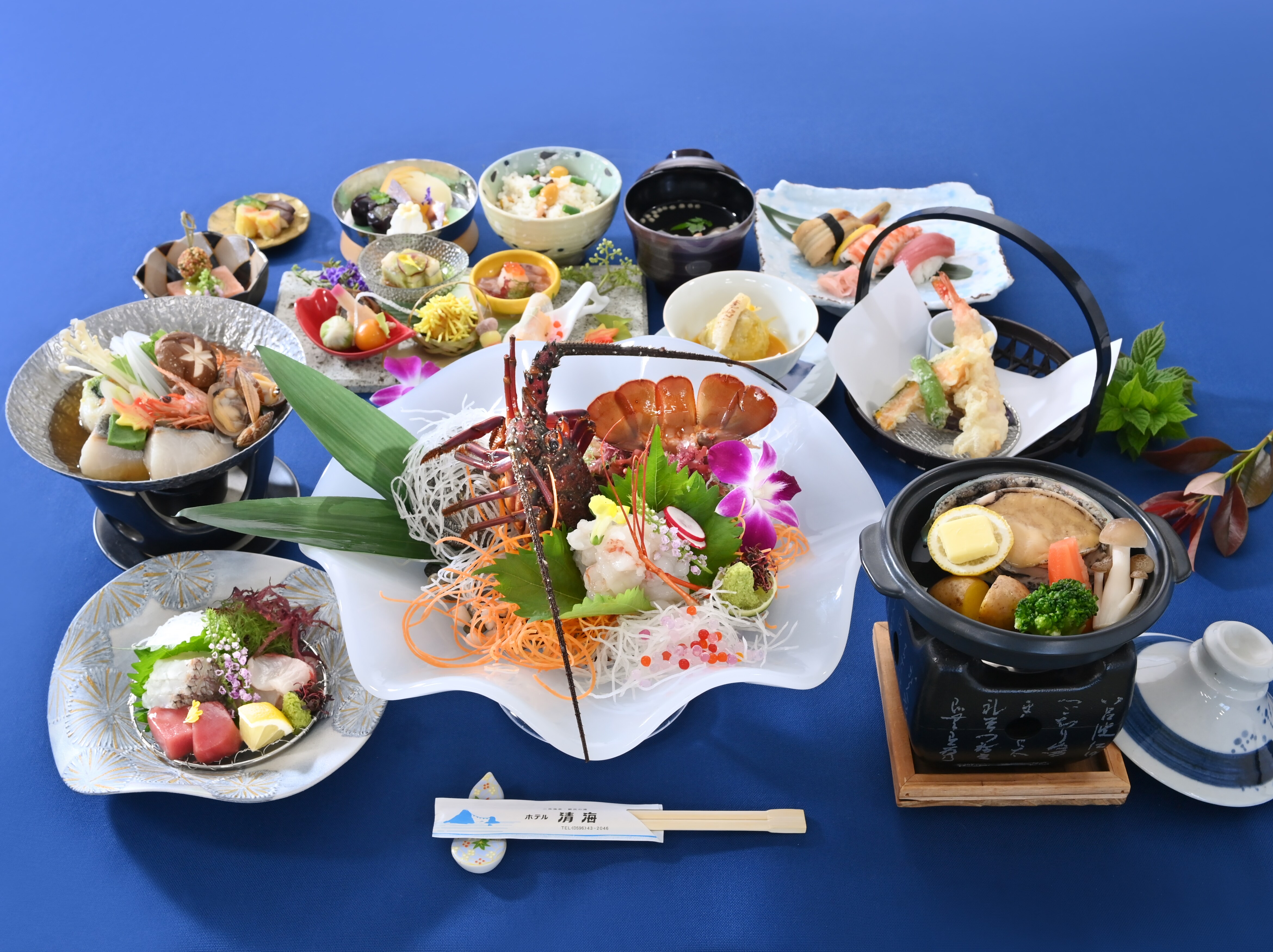 Lobster cooked in front of the guests, with abalone grilled on a ceramic plate (image of dish)