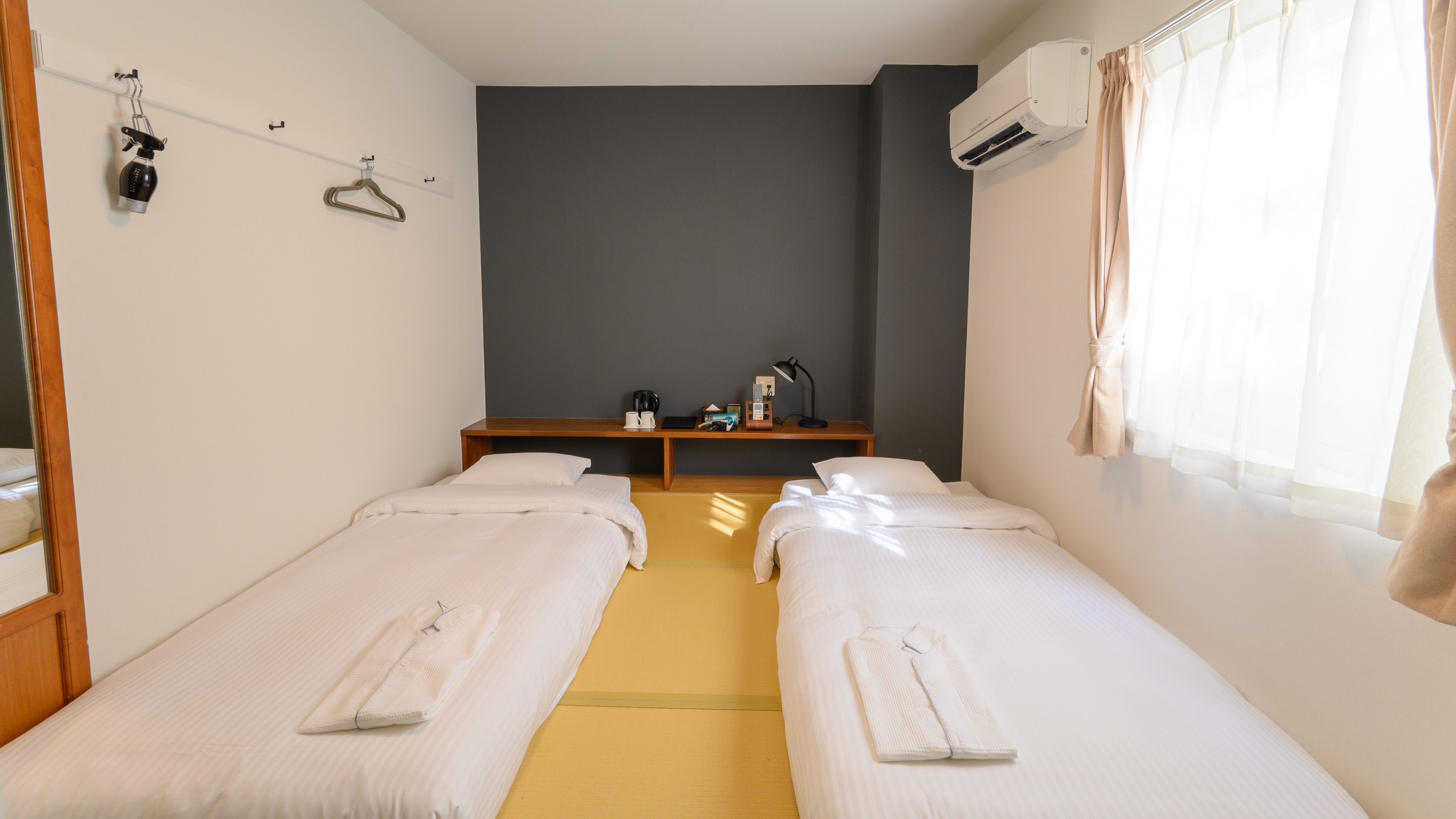 Japanese-style twin room: With tatami mats and low beds, this room is perfect for traveling with small children. (Example of a guest room)