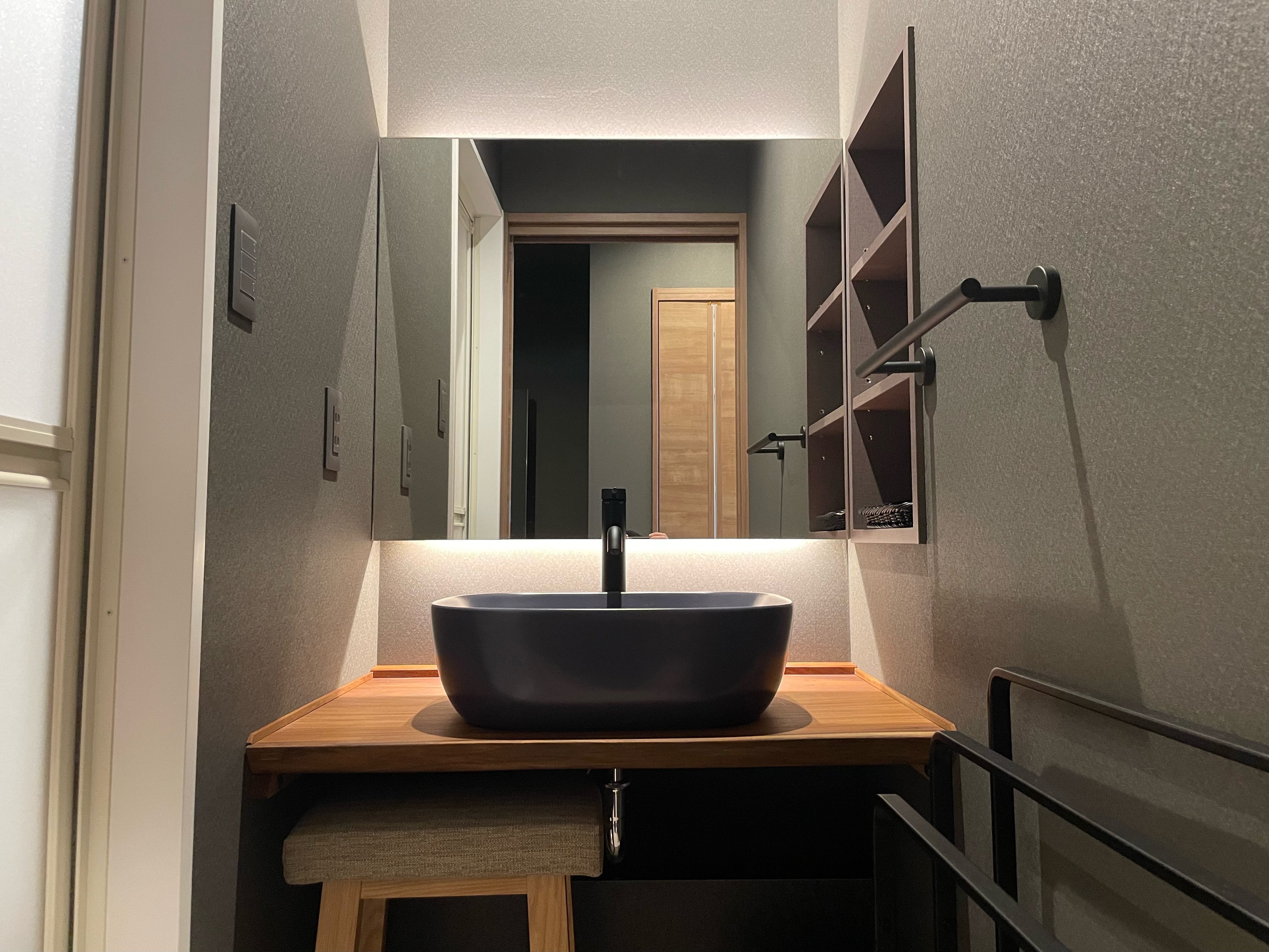 Twin room with projector and washbasin