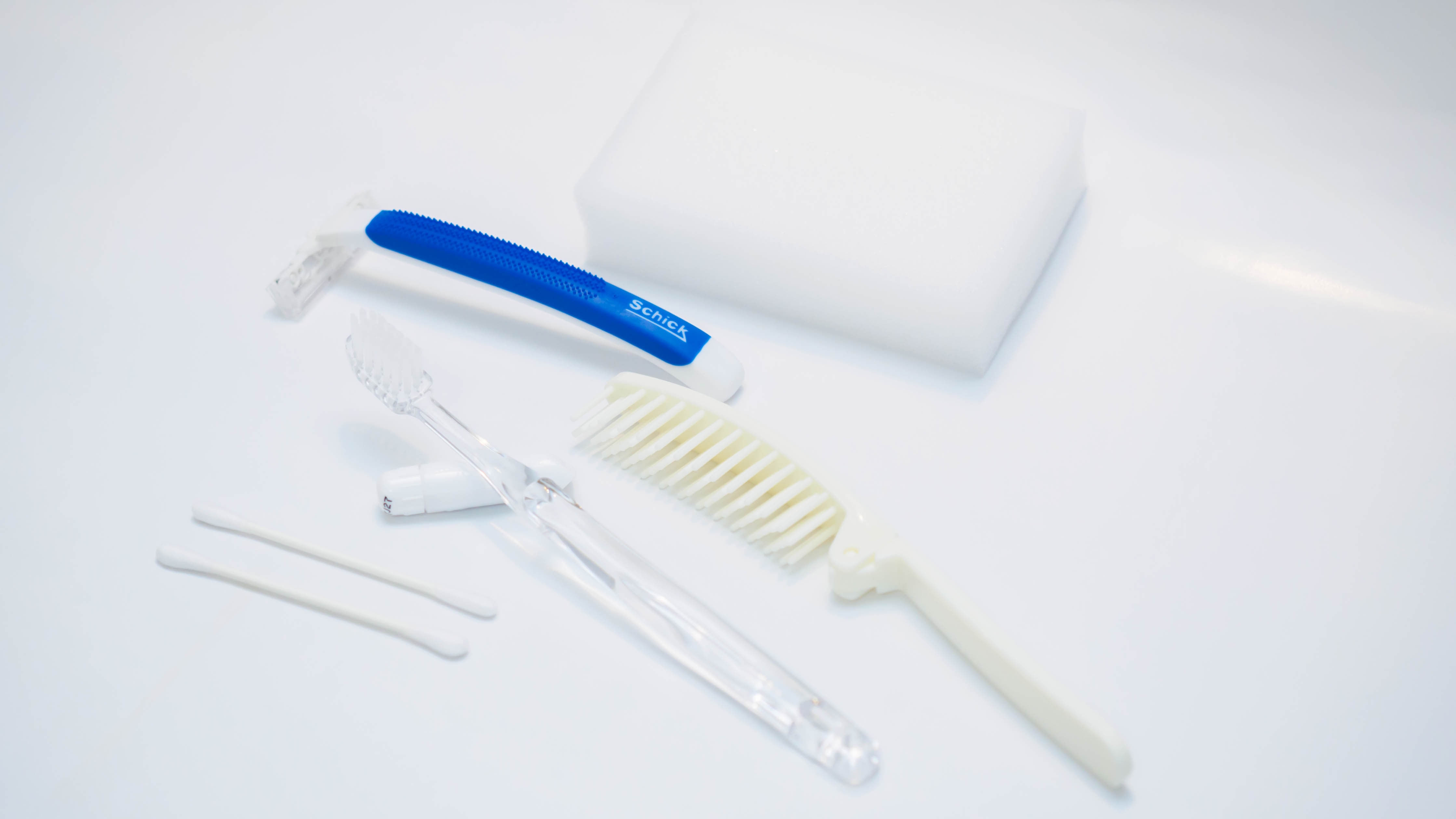 Bathroom amenities (toothbrush, hairbrush, shaver, body sponge, cotton swab)