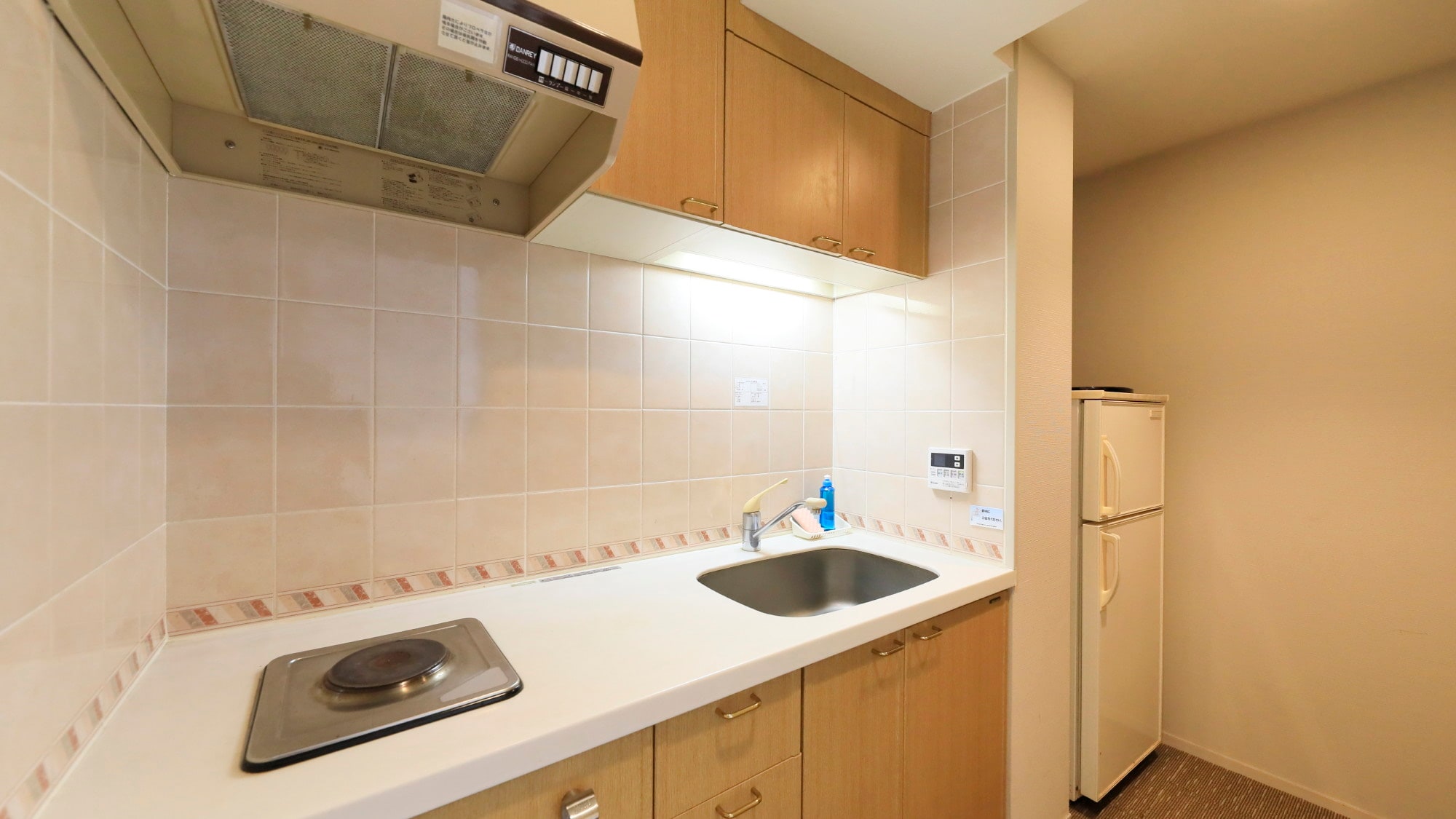 A fully equipped kitchen with microwave and other cooking utensils *Example
