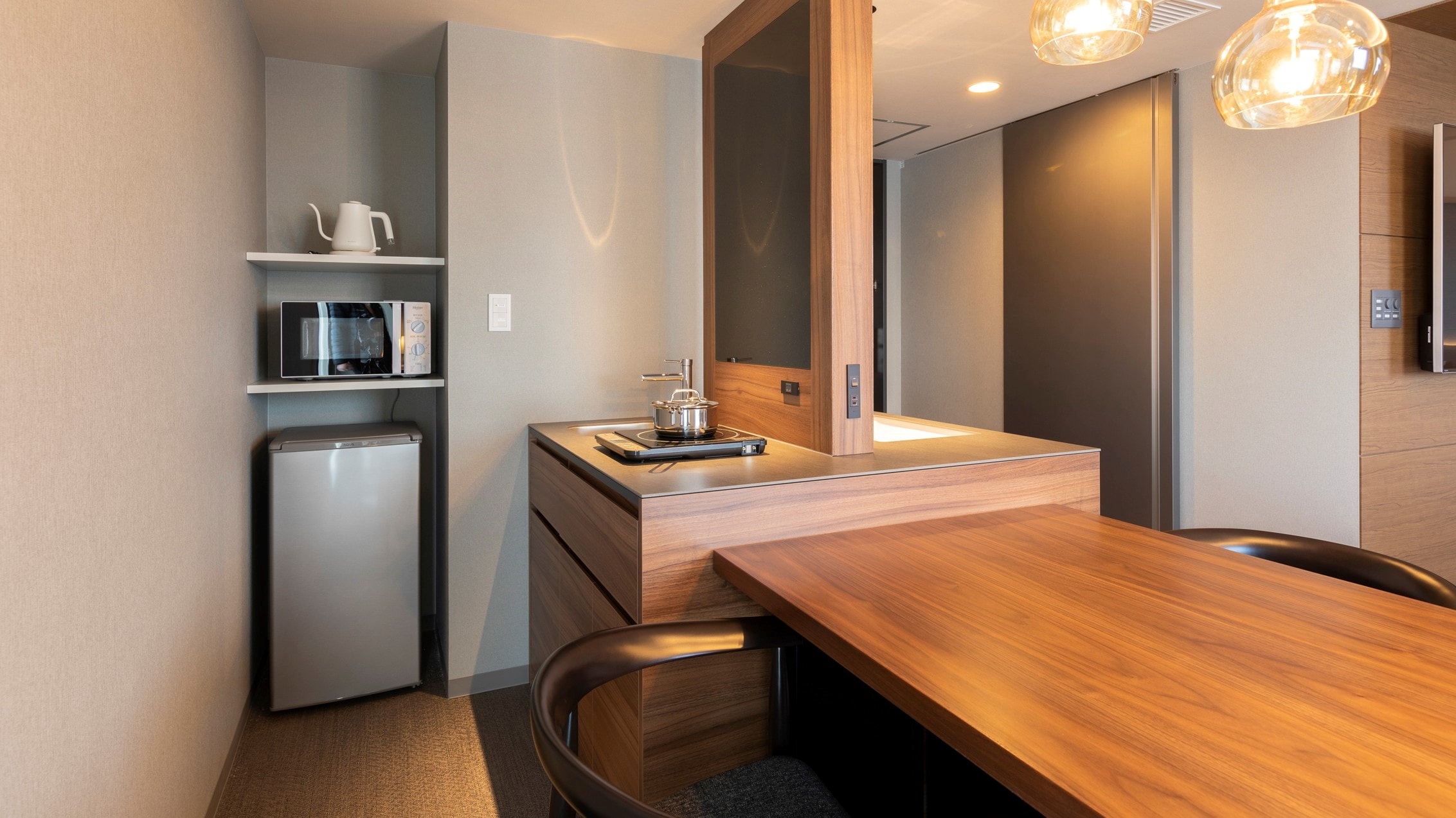 There is a refrigerator with a microwave and freezer, and a dining table so you can spend your time at home.